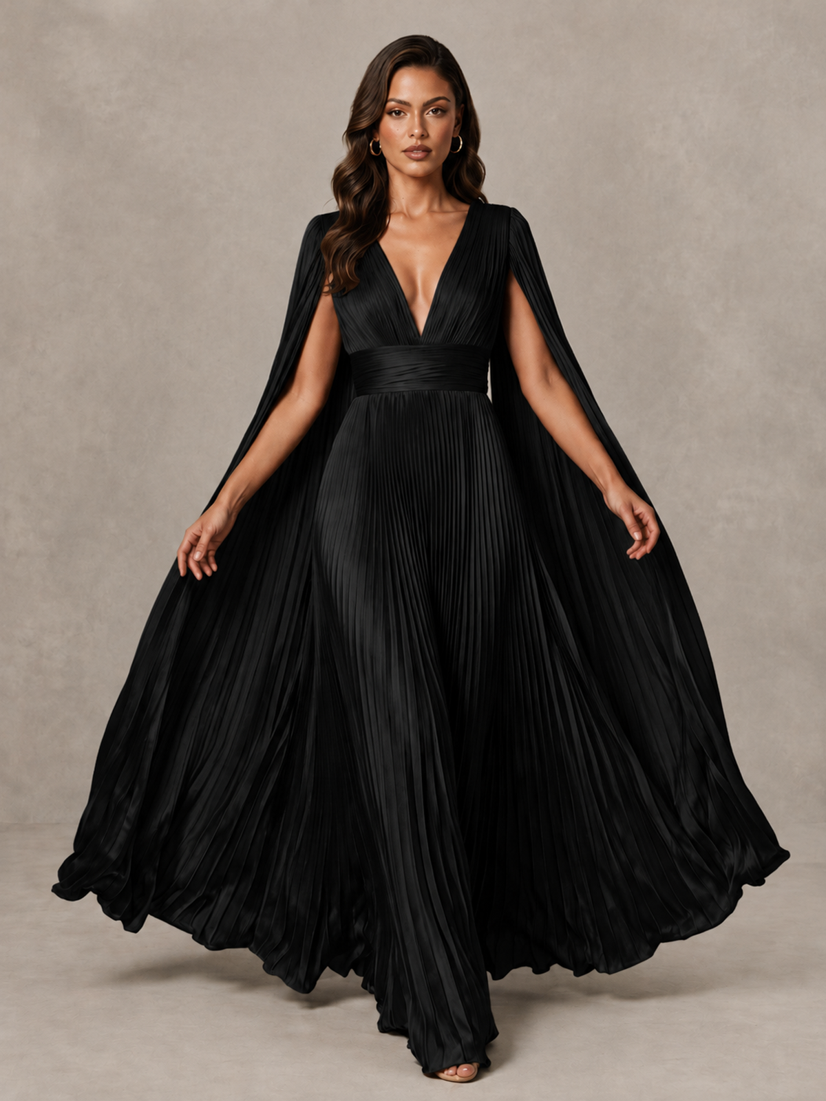 BOLODOO black pleated A-line evening gown with sweeping cape panels shown spread open