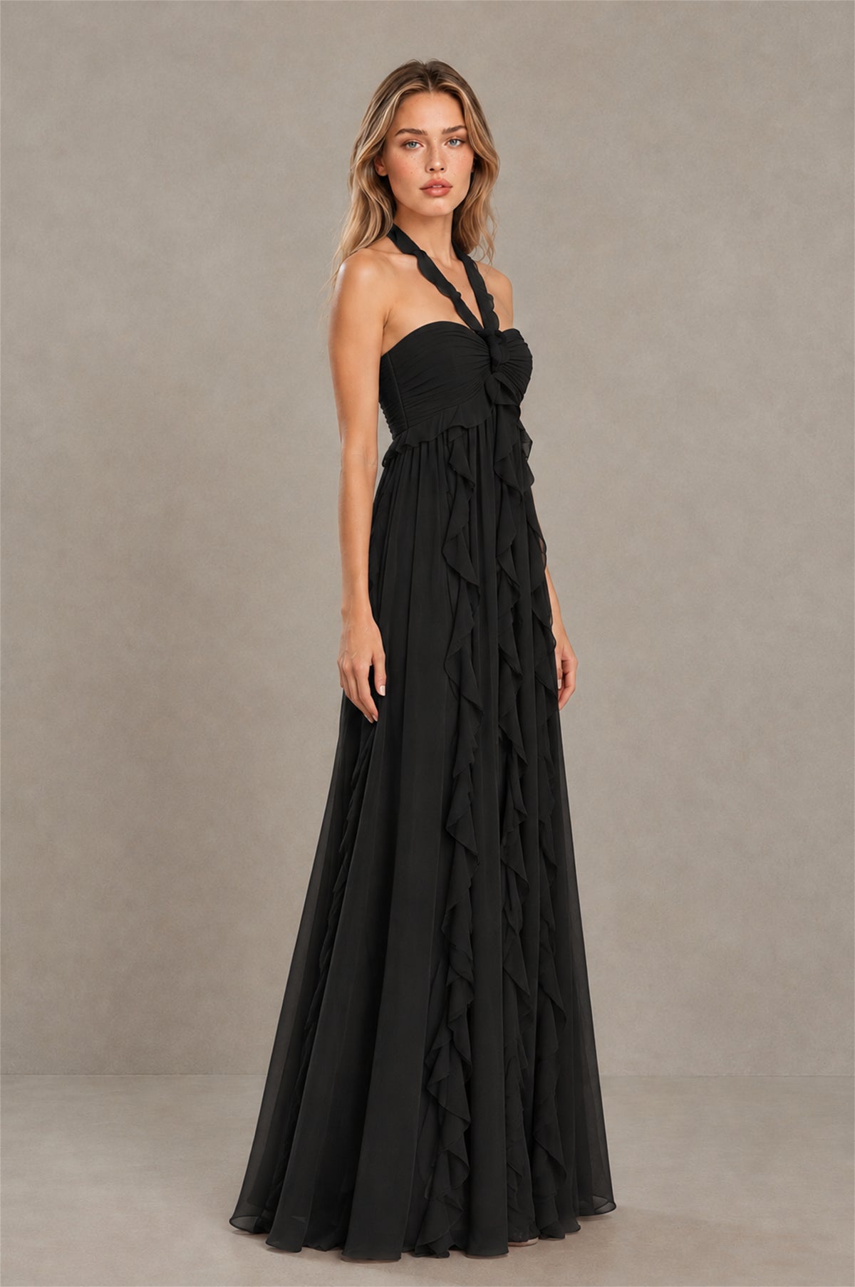 BOLODOO black halter evening gown with flowing ruffle skirt, angled side view