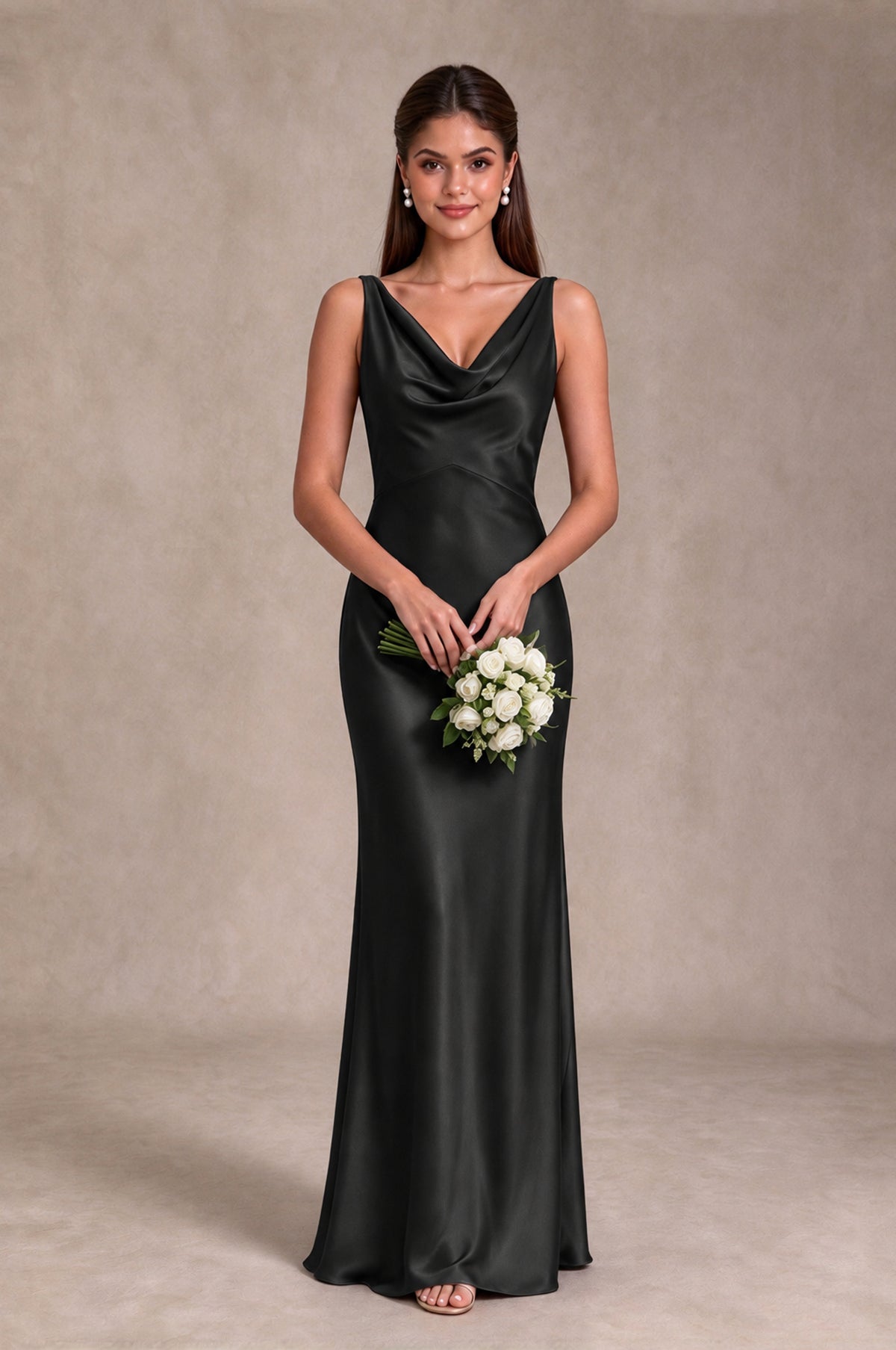 Black floor-length sleeveless bridesmaid gown with draped cowl neckline, front bouquet pose