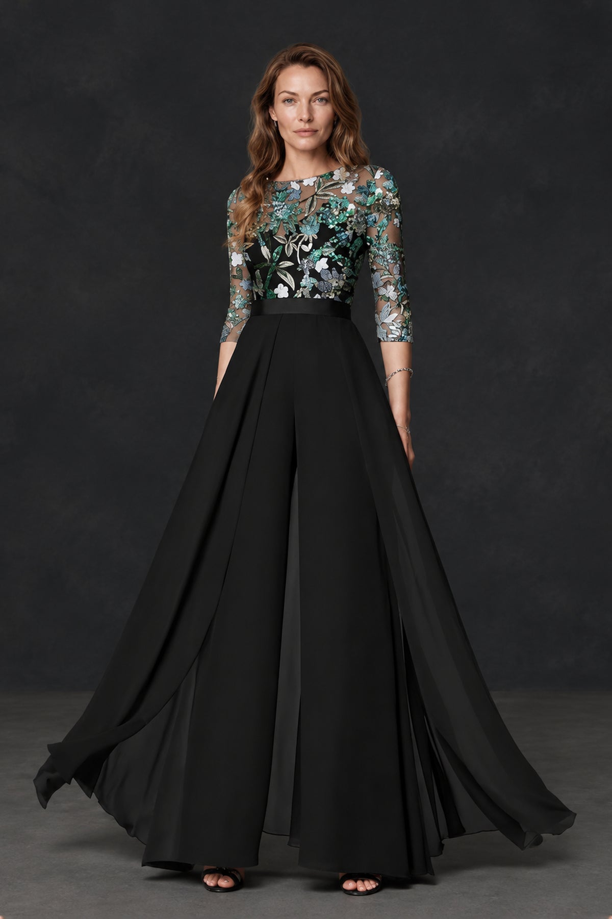 Black floral embroidered mother of the bride gown with flowing full A-line skirt, front movement view