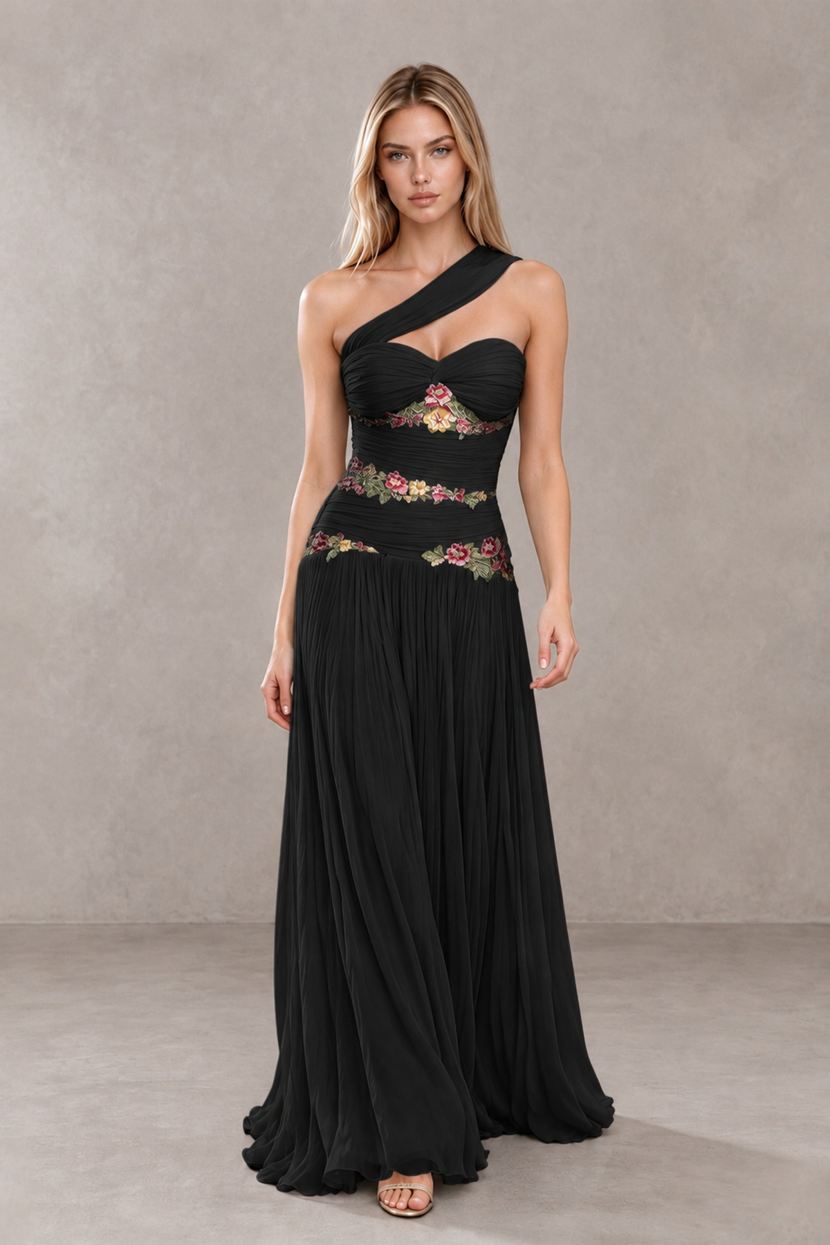 BOLODOO black floral applique gown with asymmetrical strap and flowing skirt, front walking view