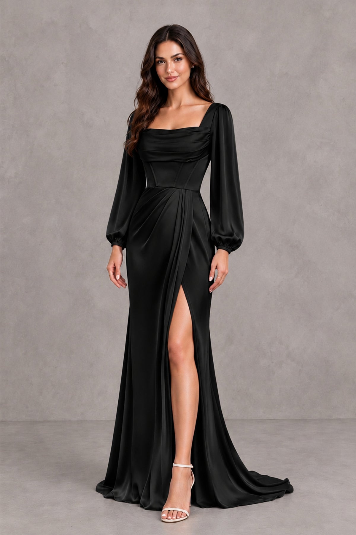 BOLODOO black floor-length evening gown showing bishop sleeves, ruched waist and high slit, hand-on-hip front view