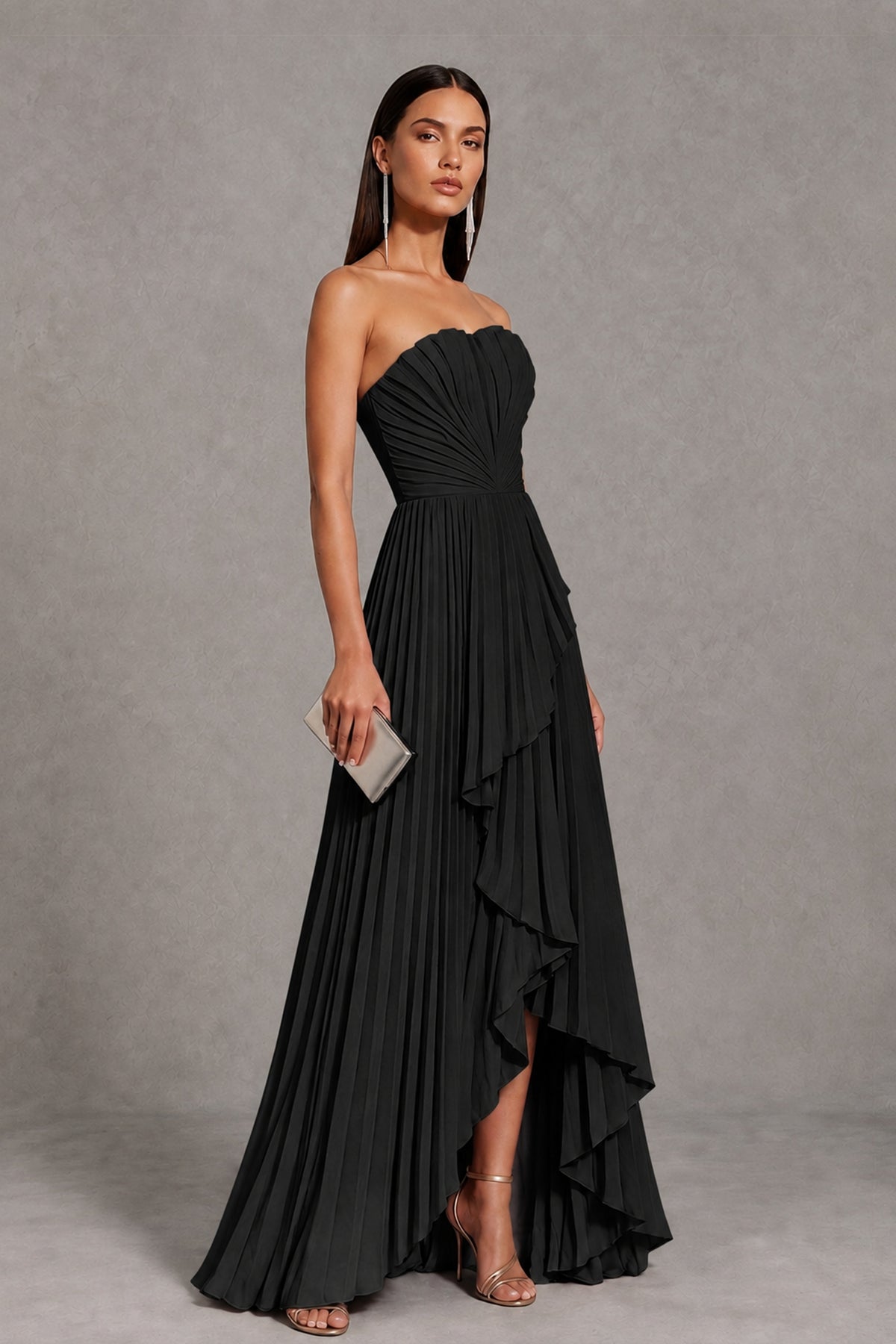 Side view of BOLODOO black strapless high-low formal dress showing pleats and layered hem