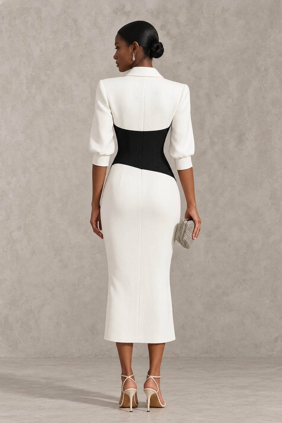 Back view of BOLODOO black and white women's suit dress with covered back and three-quarter sleeves