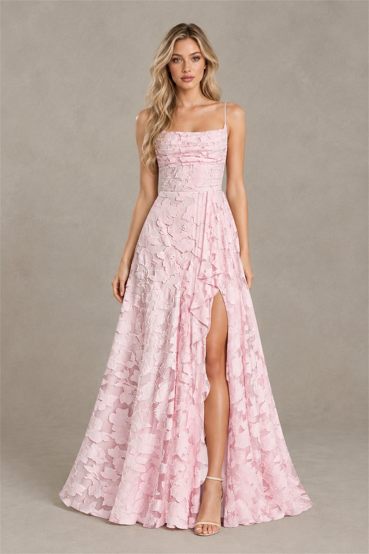 Three quarter view of blush pink floral appliqué occasion dress with front slit