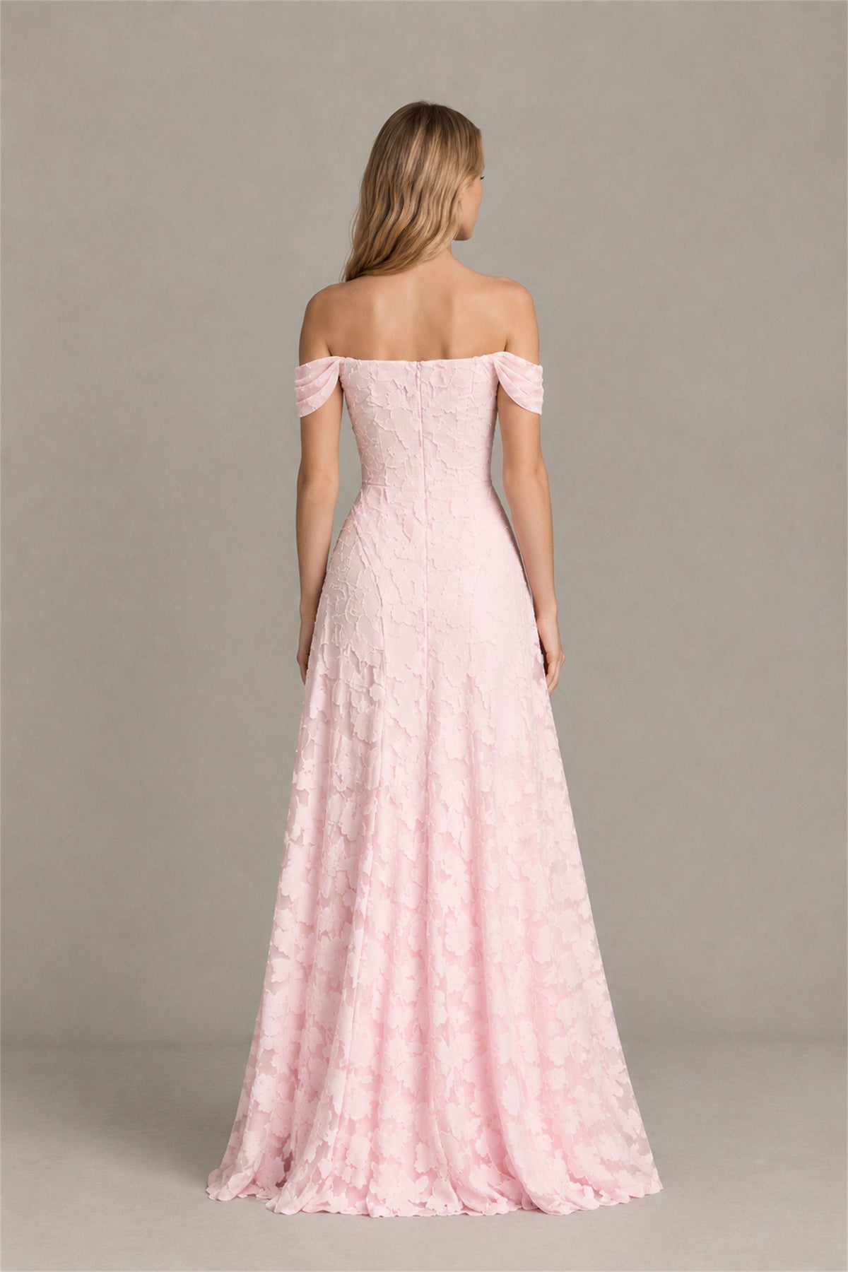 Side profile of floor length blush pink floral textured formal dress