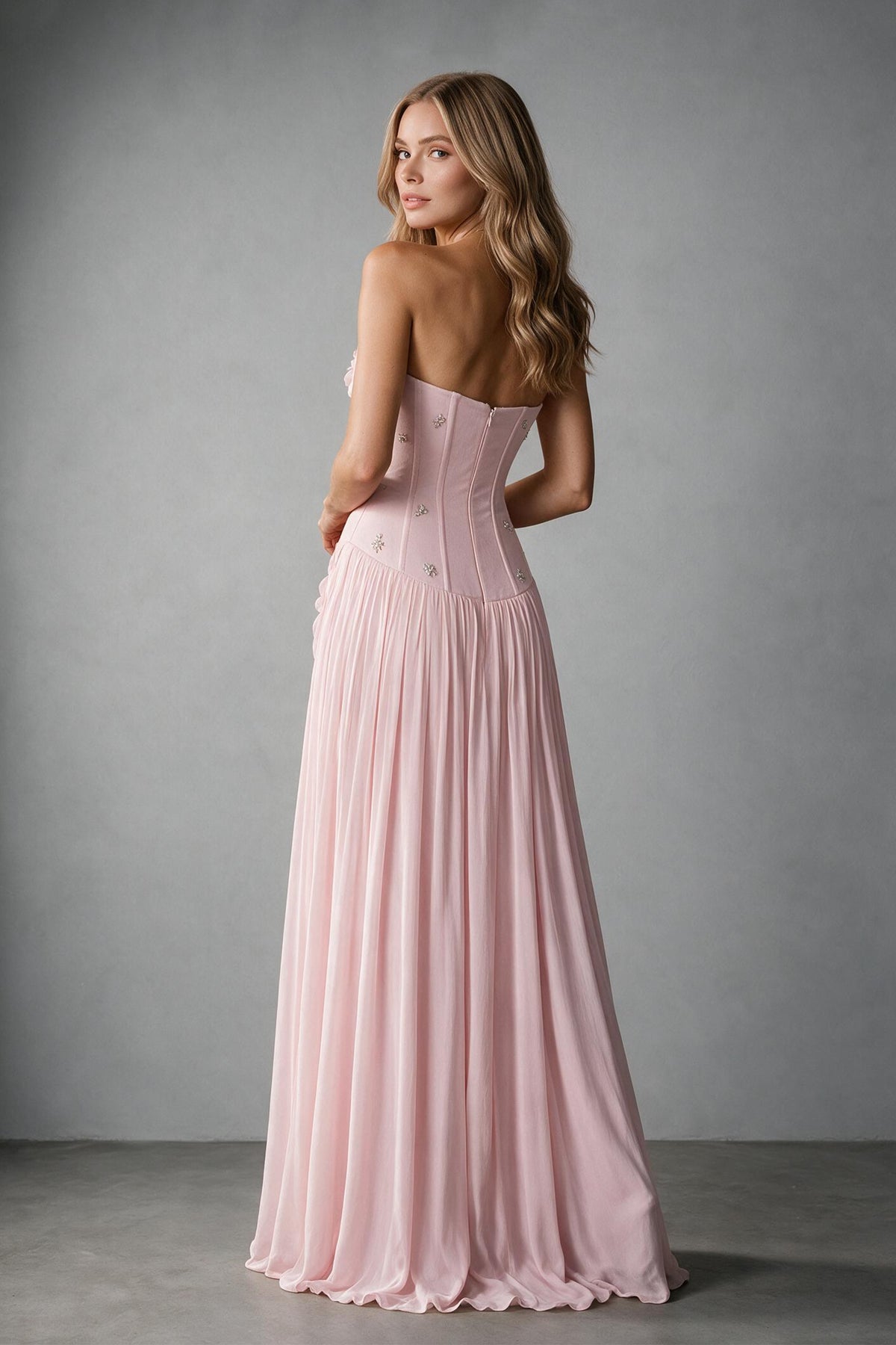 BOLODOO blush pink strapless evening gown showing open upper-back detail and pleated skirt