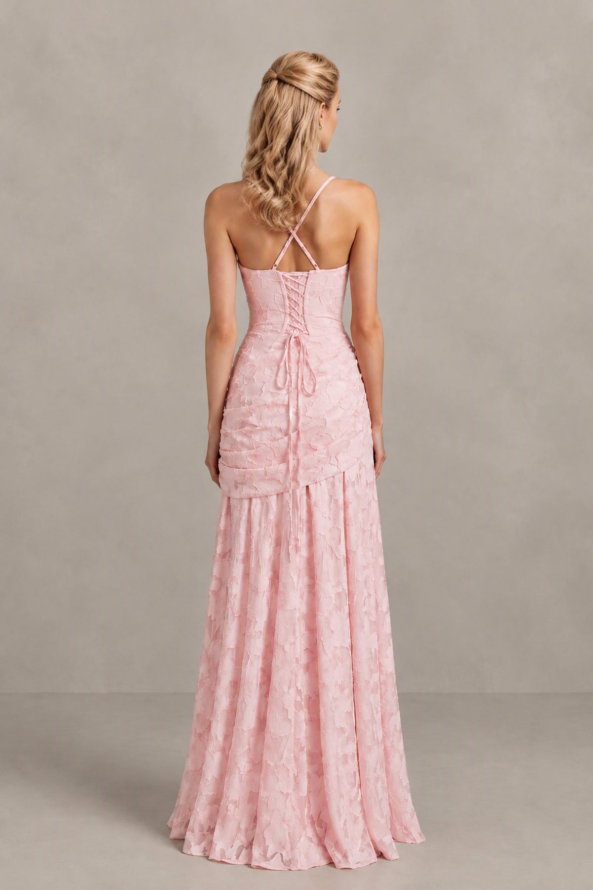 Three-quarter view of BOLODOO blush pink ruched maxi dress with slim straps and flared skirt