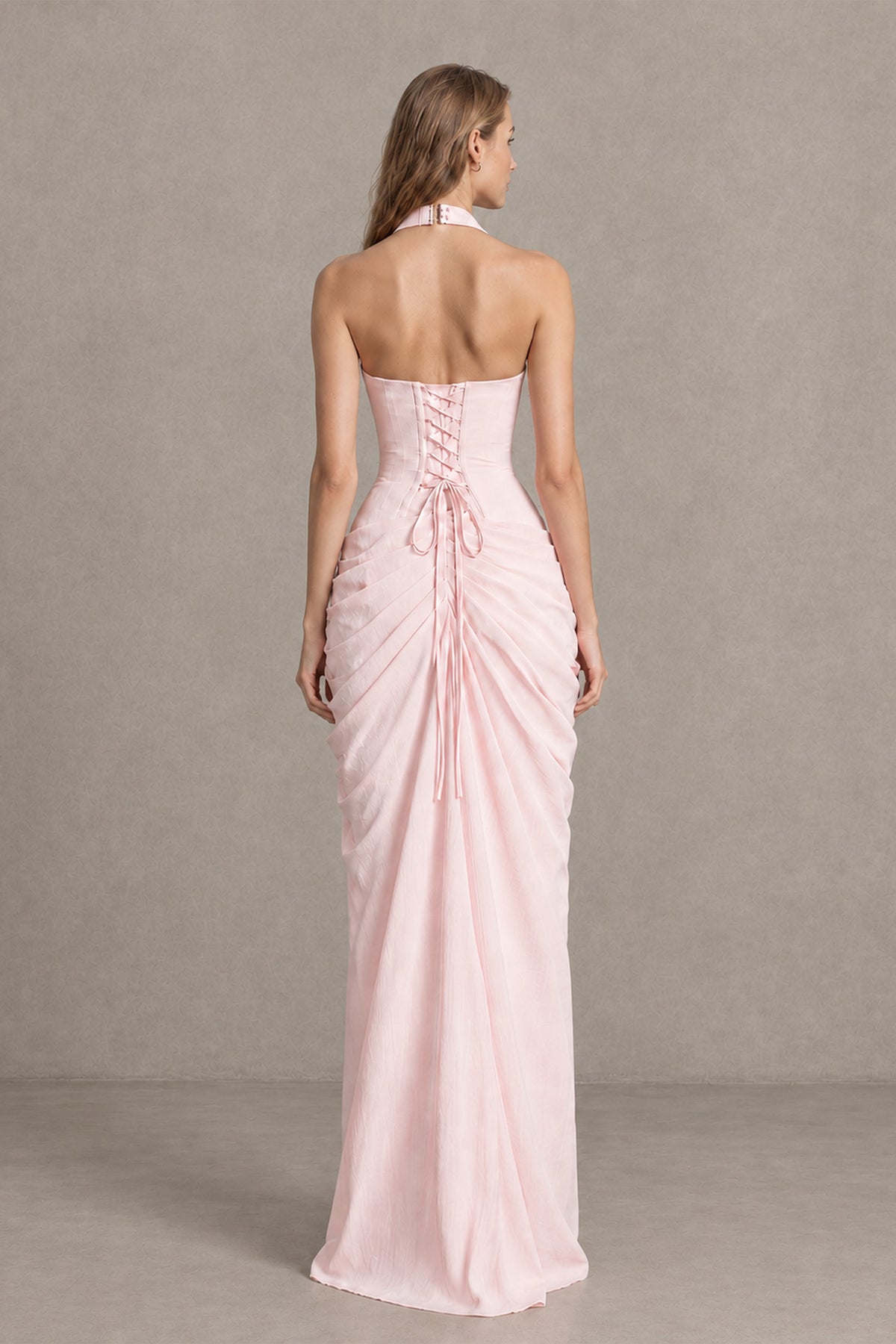 Back view of BOLODOO blush pink maxi dress showing open upper back and lace-up fastening