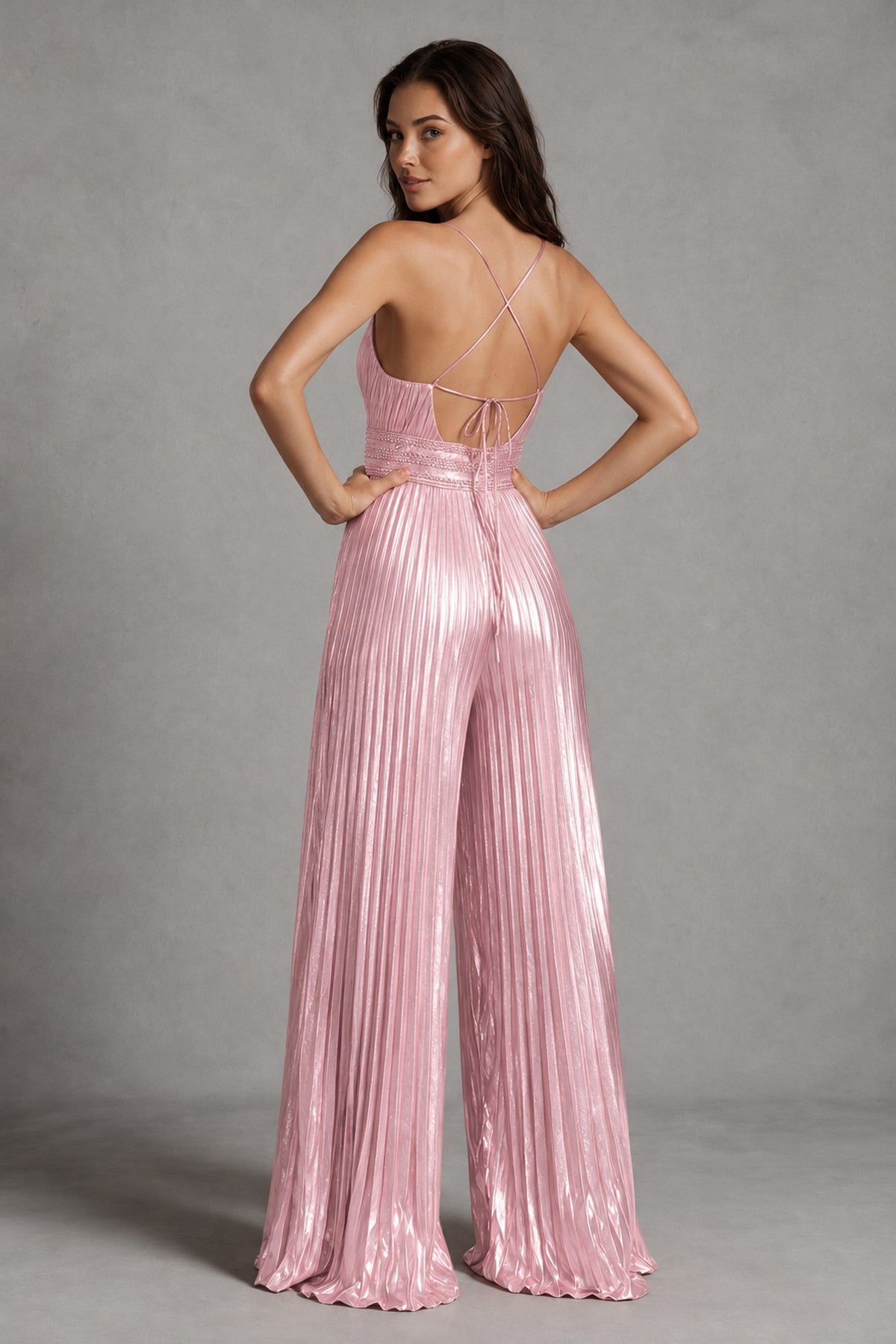 Back view of BOLODOO blush pink jumpsuit showing open back, crossed straps and tie detail