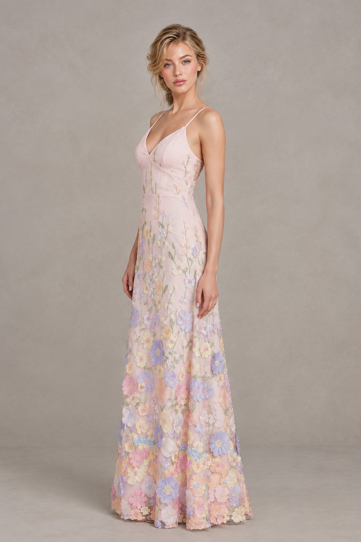 Side view of a blush pink spaghetti strap floral appliqué maxi dress