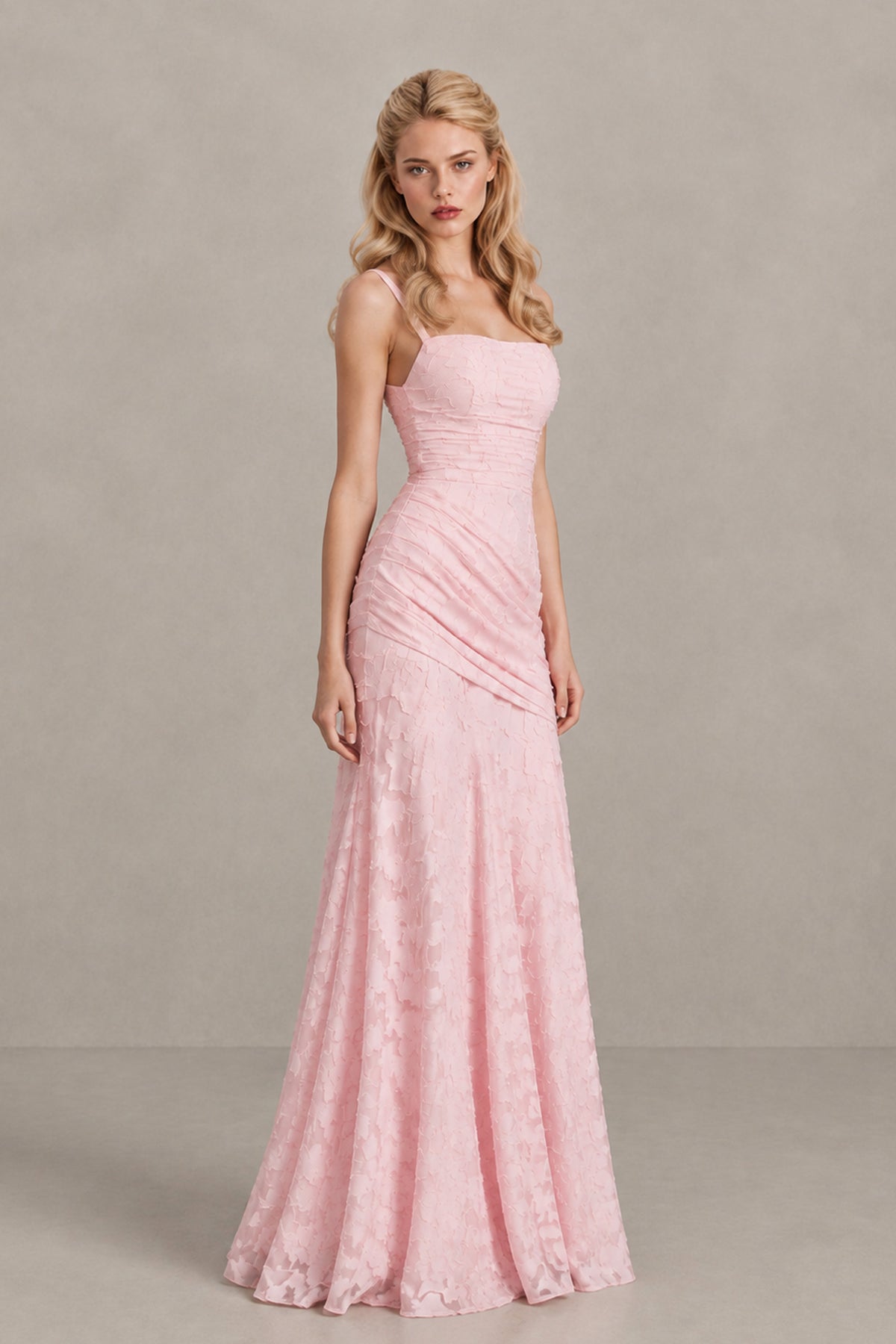 Full-length front view of blush pink floral-textured formal dress with asymmetric hip draping