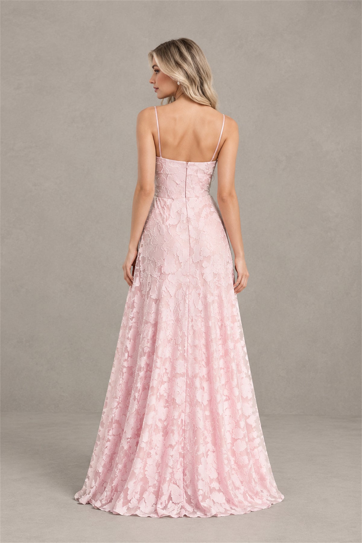 Front full-length view of blush pink floral A-line gown with ruffled slit