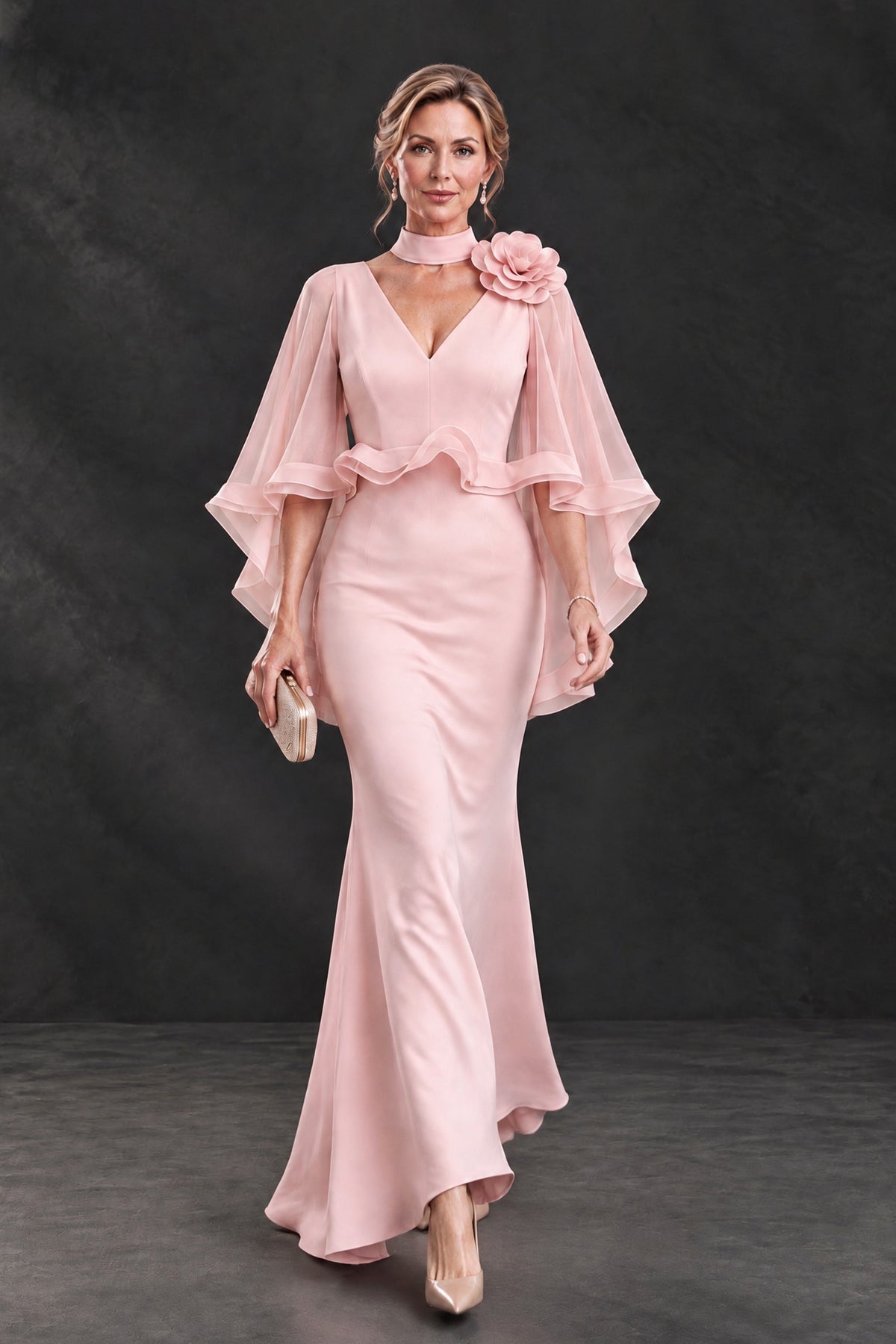 BOLODOO blush pink floral cape sleeve mother of the bride dress showing flowing floor-length skirt, walking front view