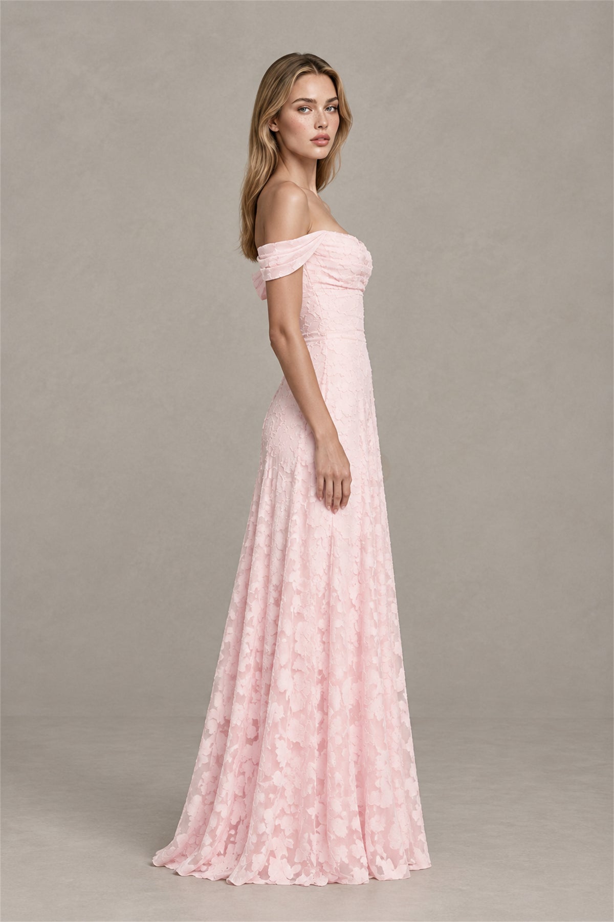 Back view of blush pink off shoulder maxi dress with covered back and flowing skirt
