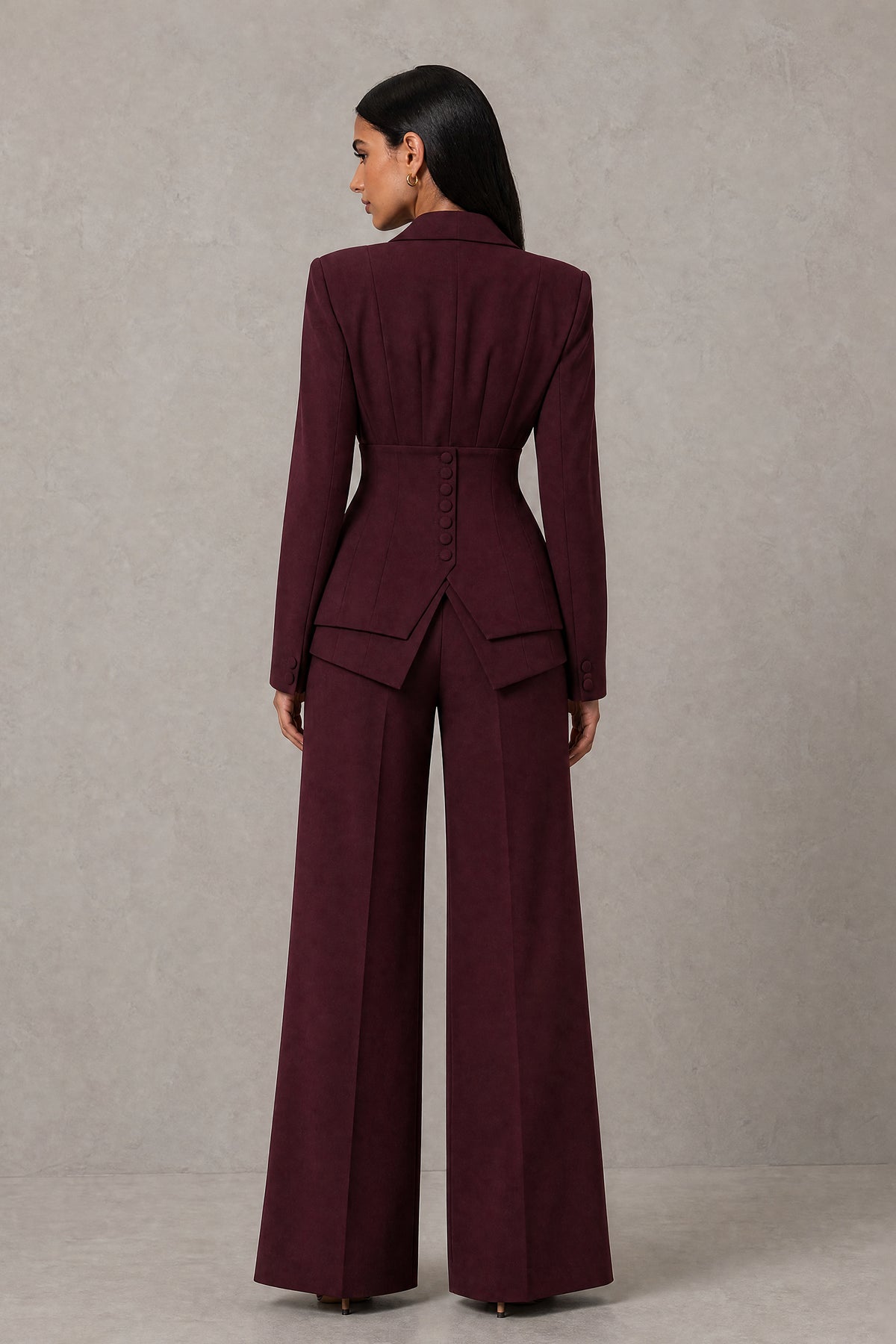 Side three quarter view of burgundy blazer and wide leg trousers suit set