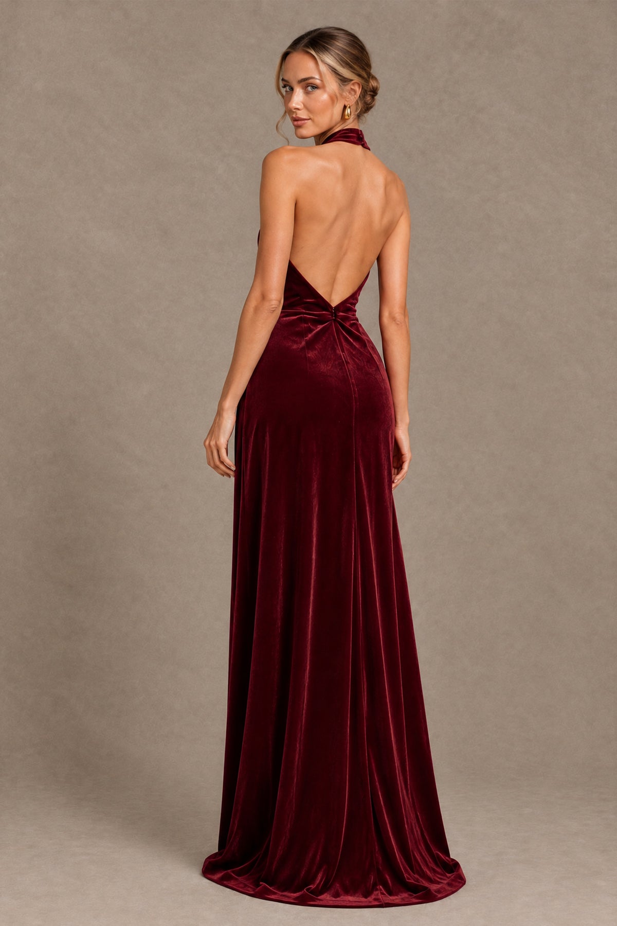 Burgundy halter evening gown with deep open back and softly trailing hem, rear view