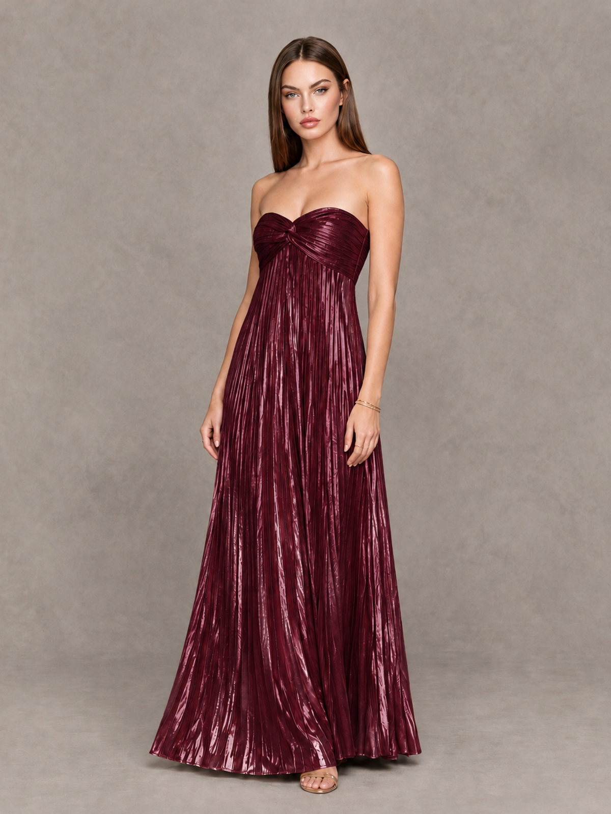 Burgundy twist-front sweetheart evening dress with flowing floor-length pleated skirt, angled front view