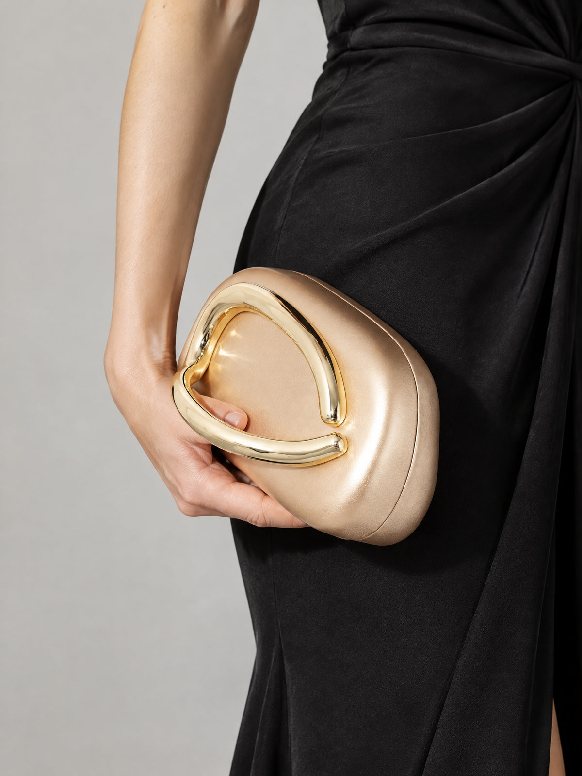 BOLODOO champagne clutch carried with a black evening dress