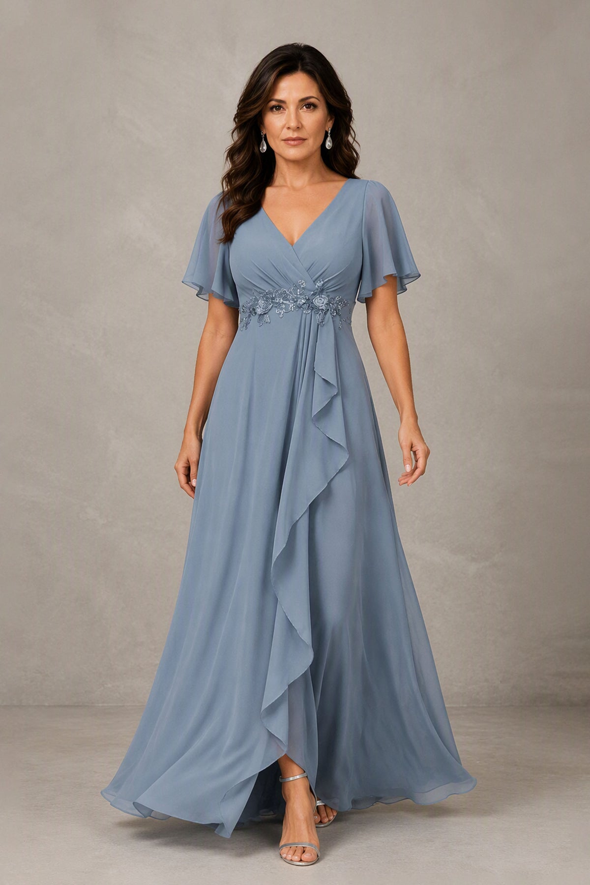 BOLODOO dusty blue chiffon maxi dress with V-neck, flutter sleeves, floral applique waist, cascade ruffle and front slit, full front view