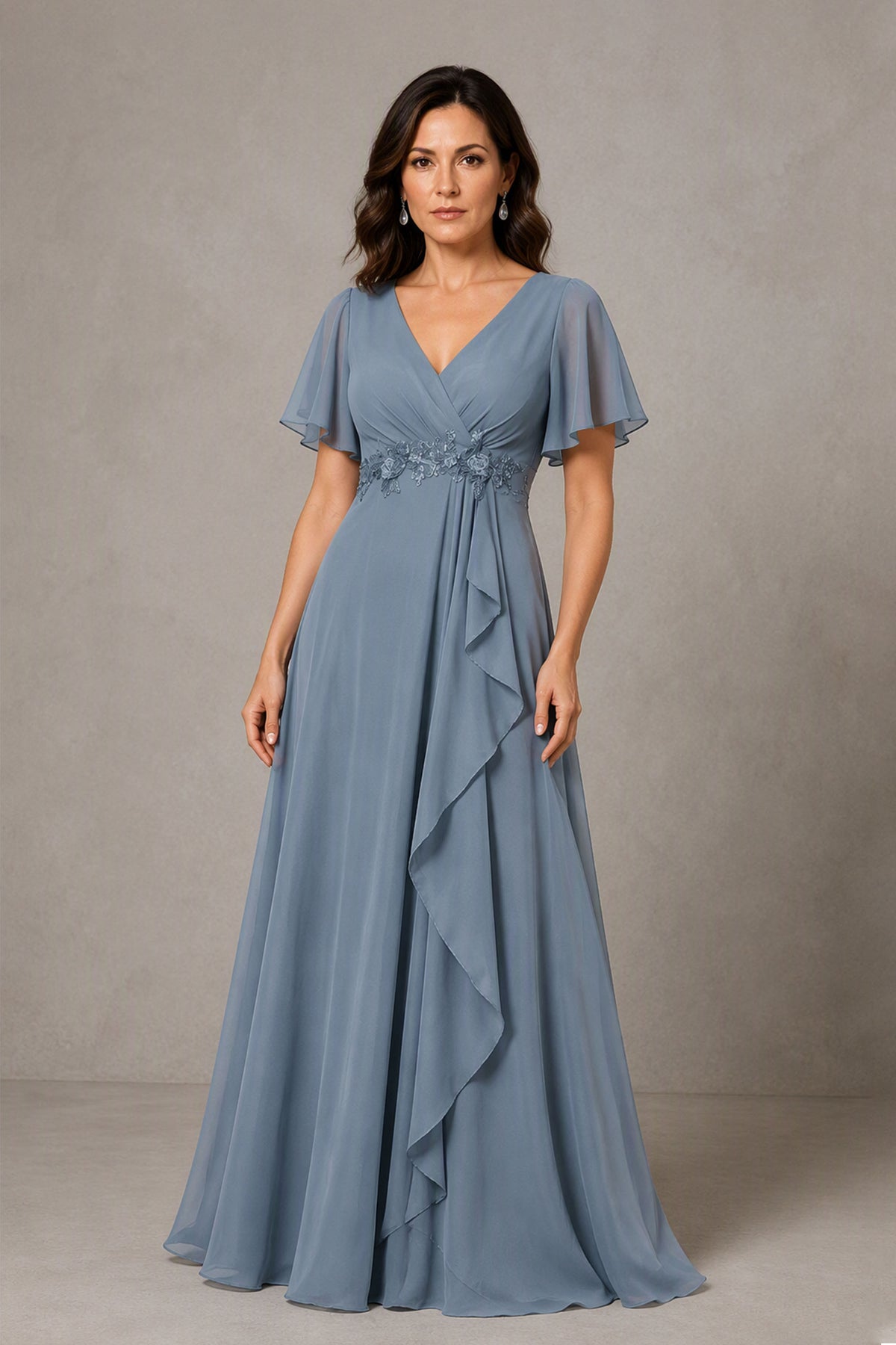 Back view of dusty blue maxi gown with open V-back and lace-up corset back detail, chiffon A-line skirt