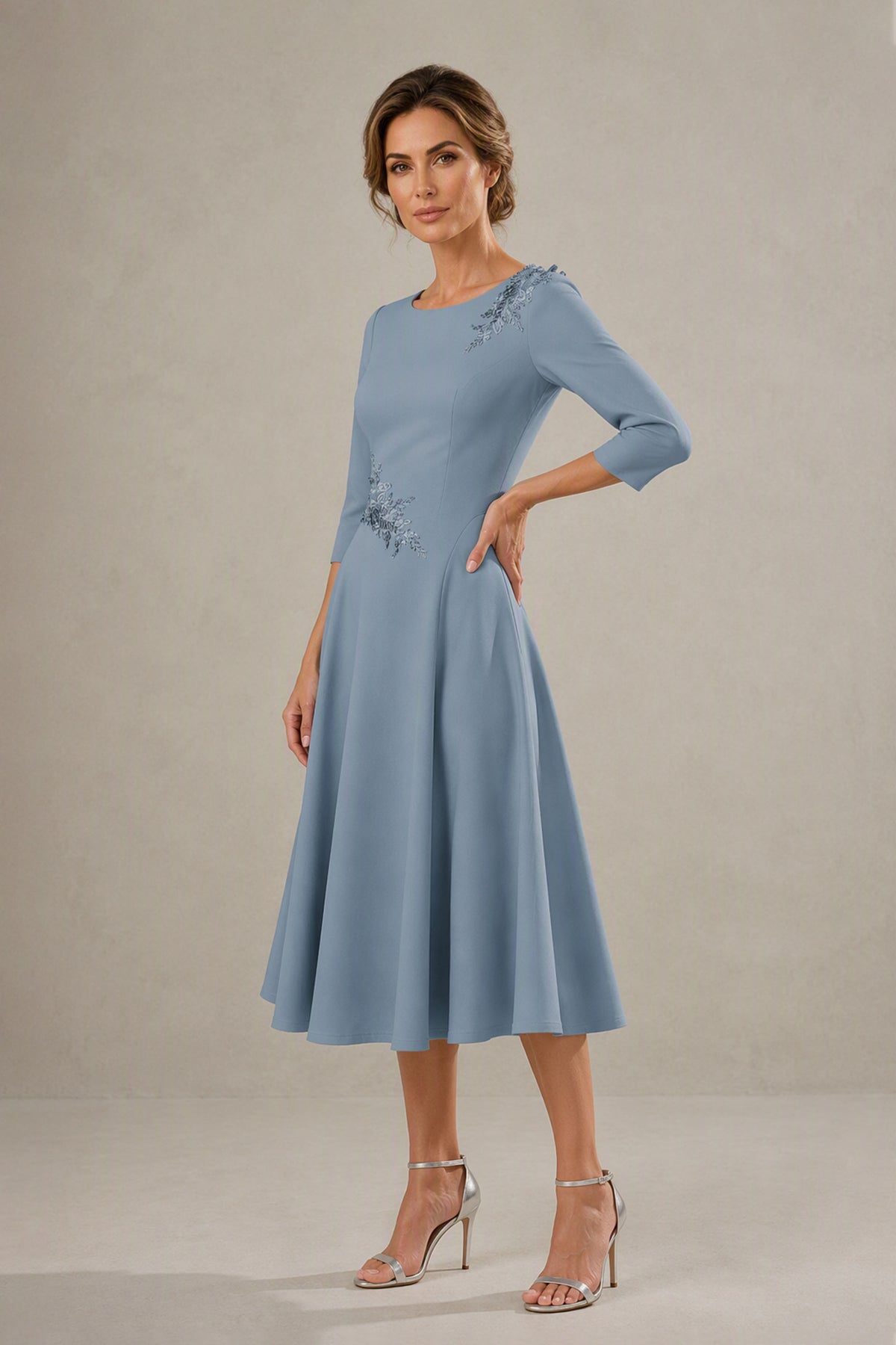 Side view of dusty blue tea length A-line dress showing fitted waist and full skirt