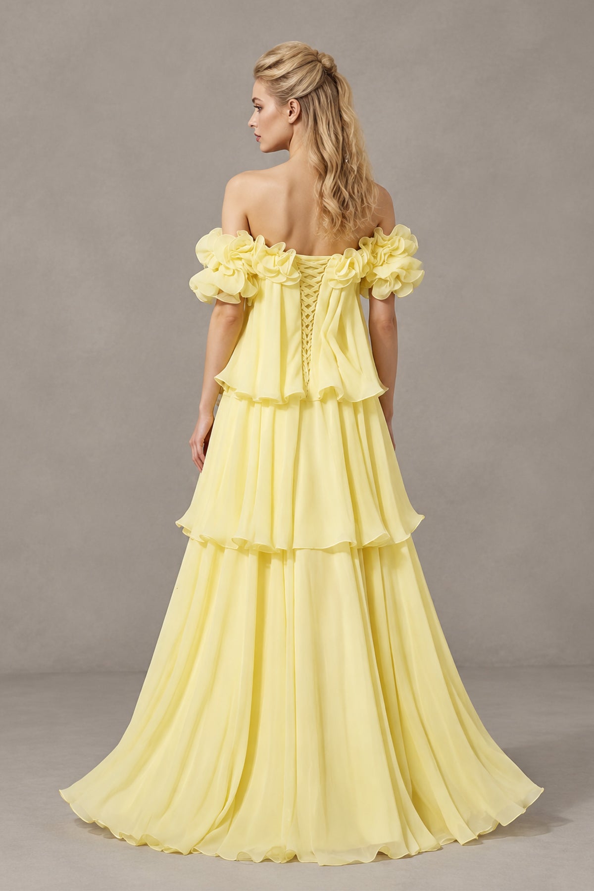 Light yellow tiered floor-length dress with floral short sleeves, front walking view