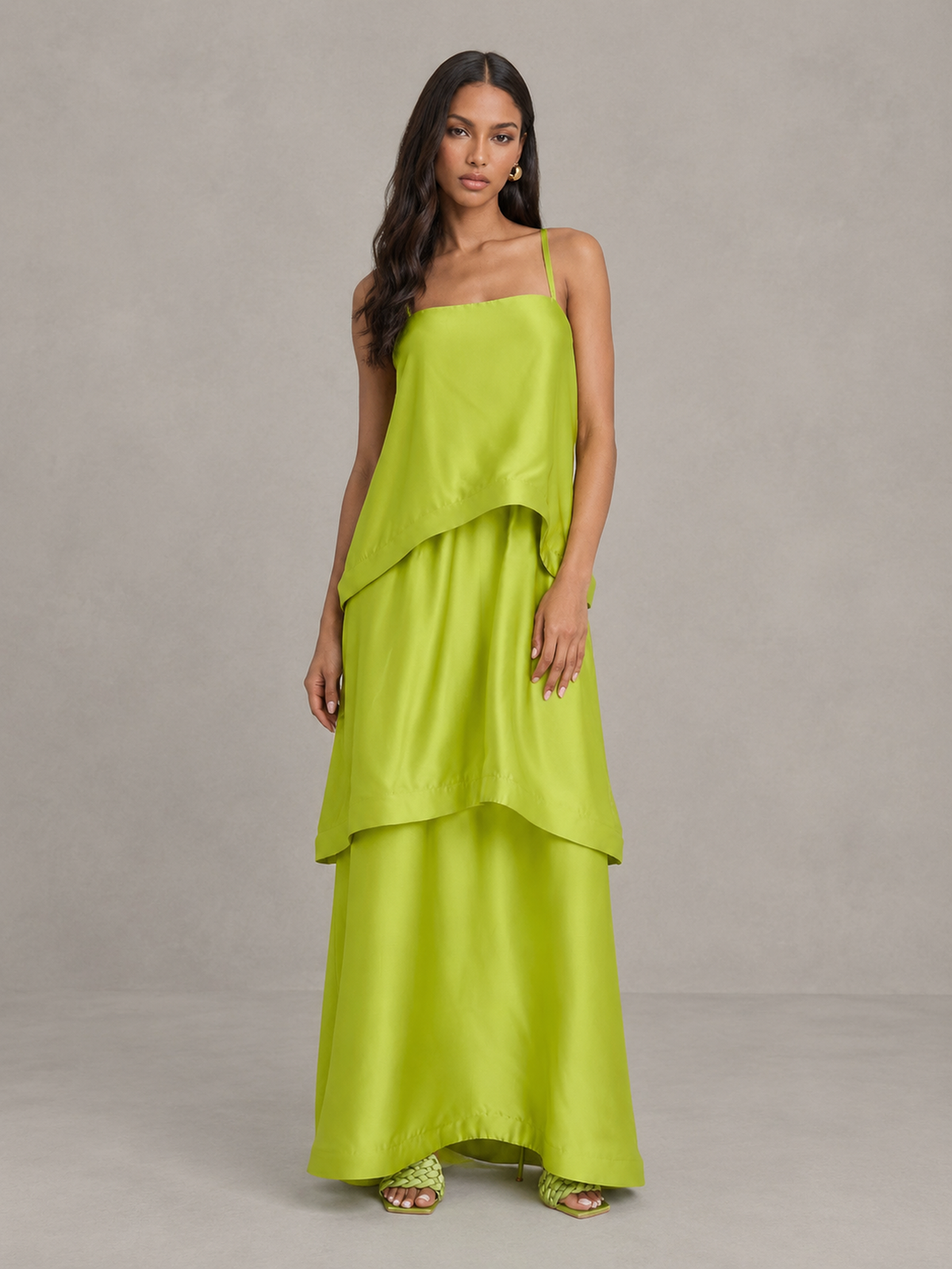 BOLODOO lime green sleeveless layered maxi dress with asymmetric overlay and flowing tiered skirt, three-quarter view