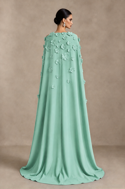 Mint green floral evening gown back view showing flowing full-length cape overlay