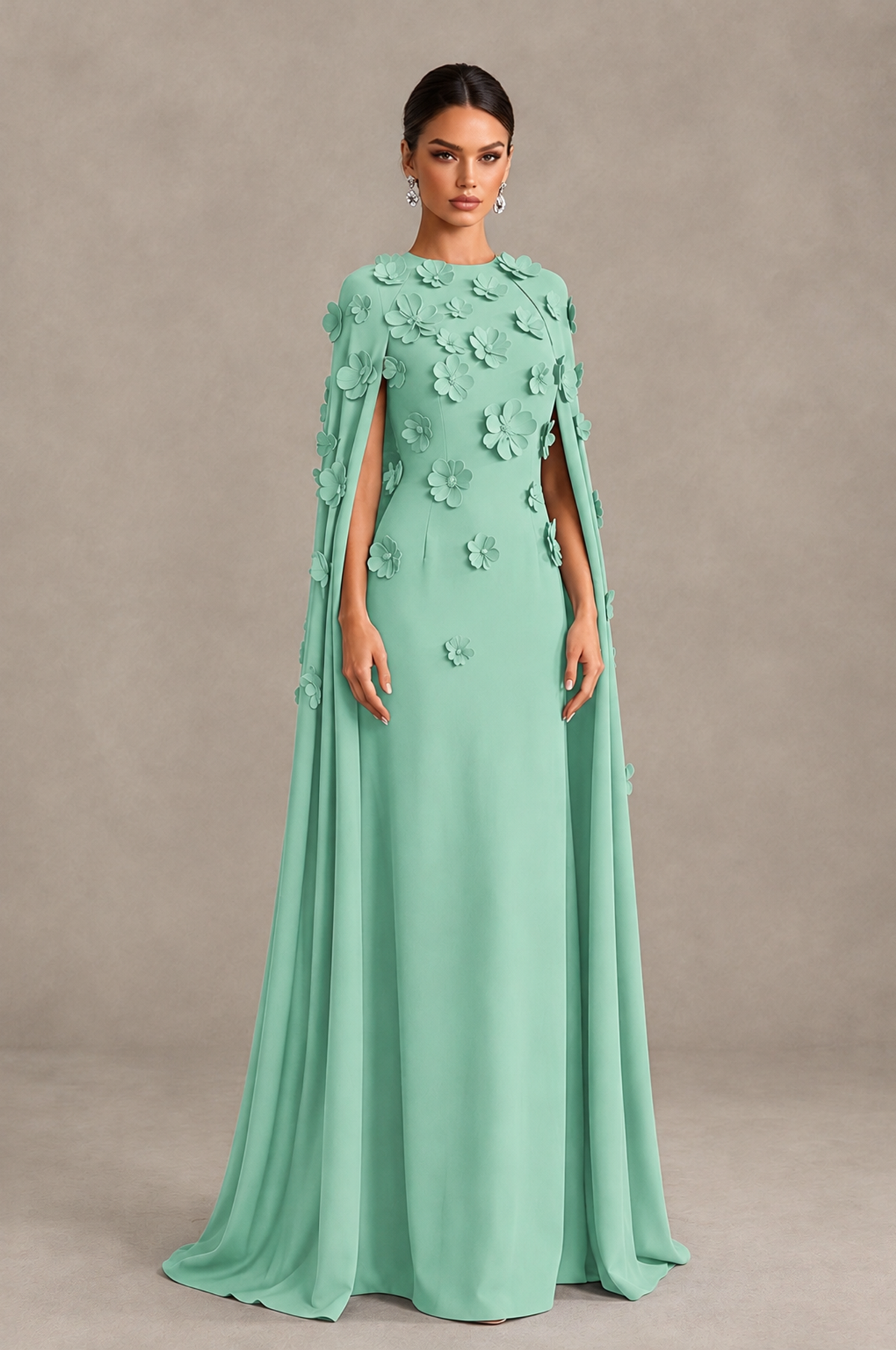 Mint green column evening gown front view showing floral appliques and floor-length cape panels