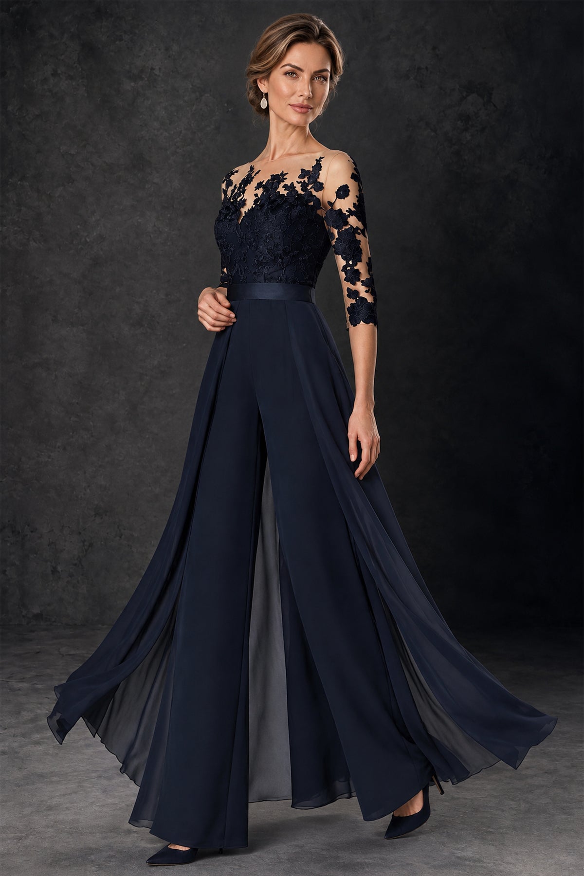 Side view of BOLODOO navy blue formal jumpsuit showing floral lace sleeves and flowing overlay