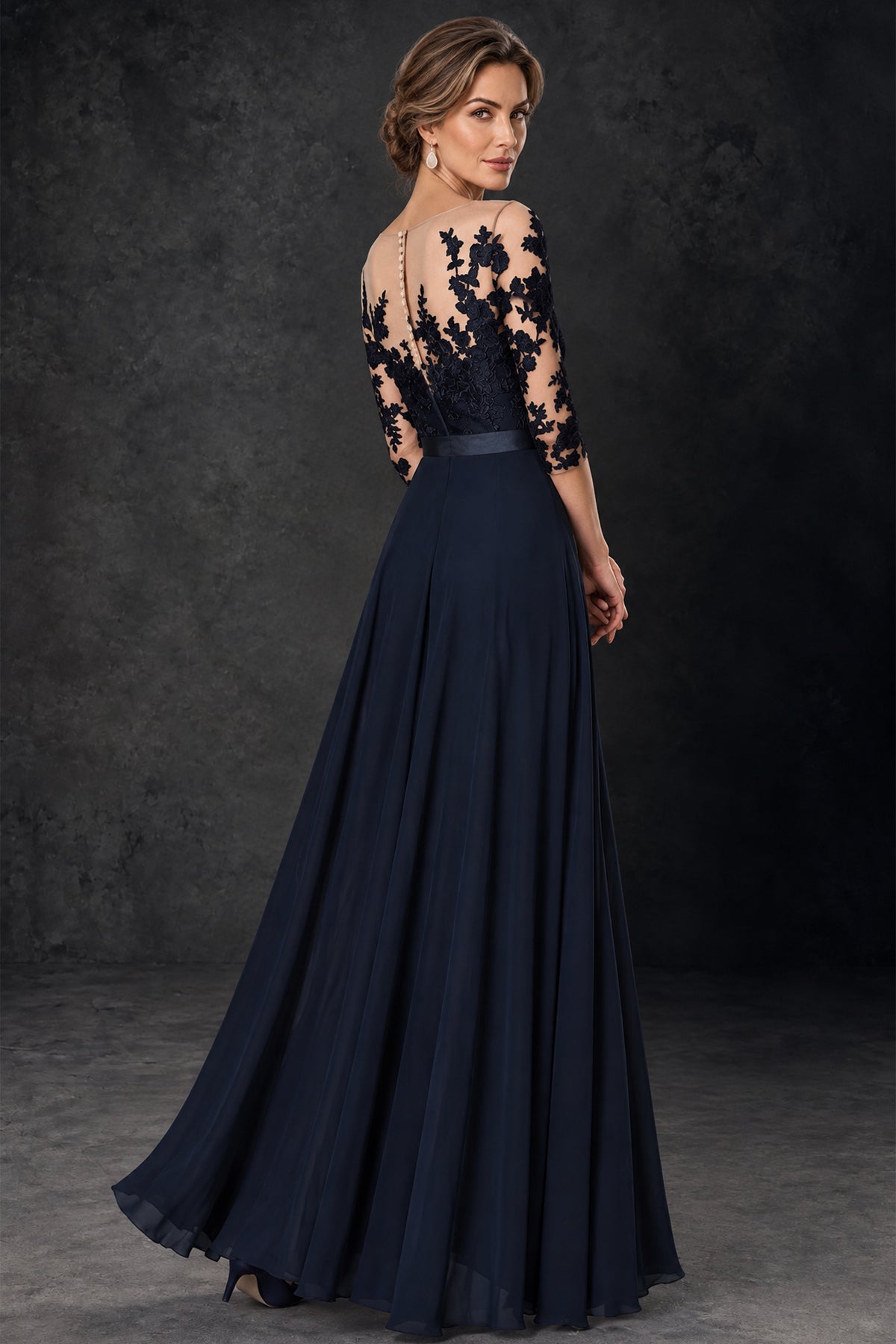 Back view of BOLODOO navy blue jumpsuit with sheer illusion lace back and flowing overlay
