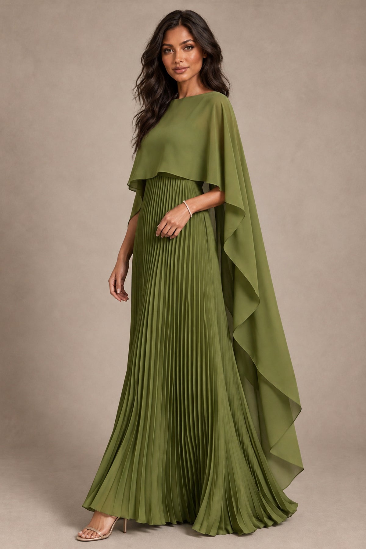 Angled front view of olive green cape gown showing accordion pleats and floor-length A-line skirt