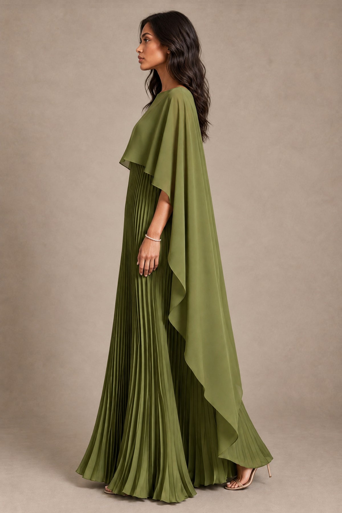 Side view of BOLODOO olive green pleated maxi dress with cascading cape overlay