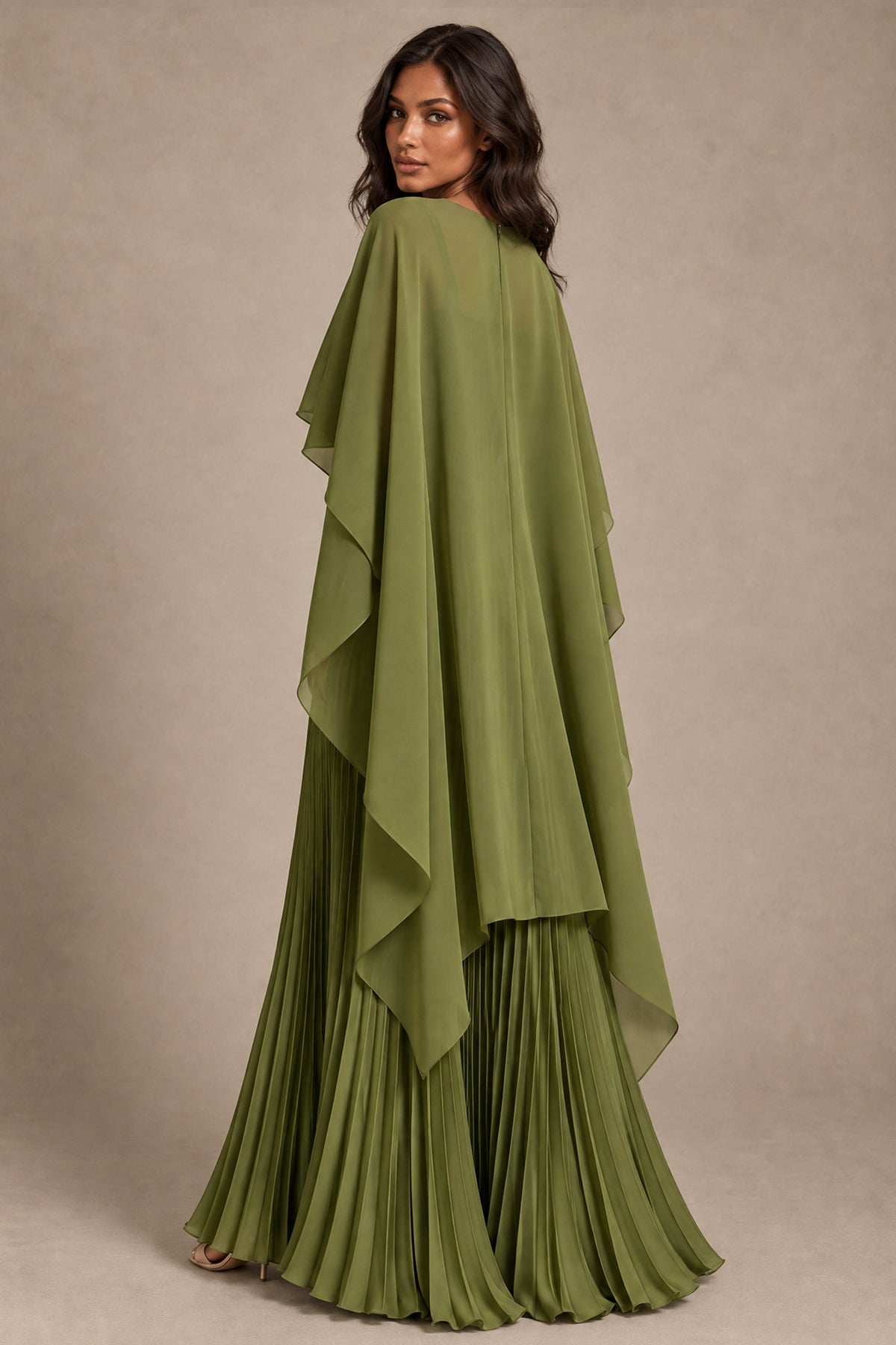 Back view of olive green evening gown with flowing covered-back cape and pleated skirt
