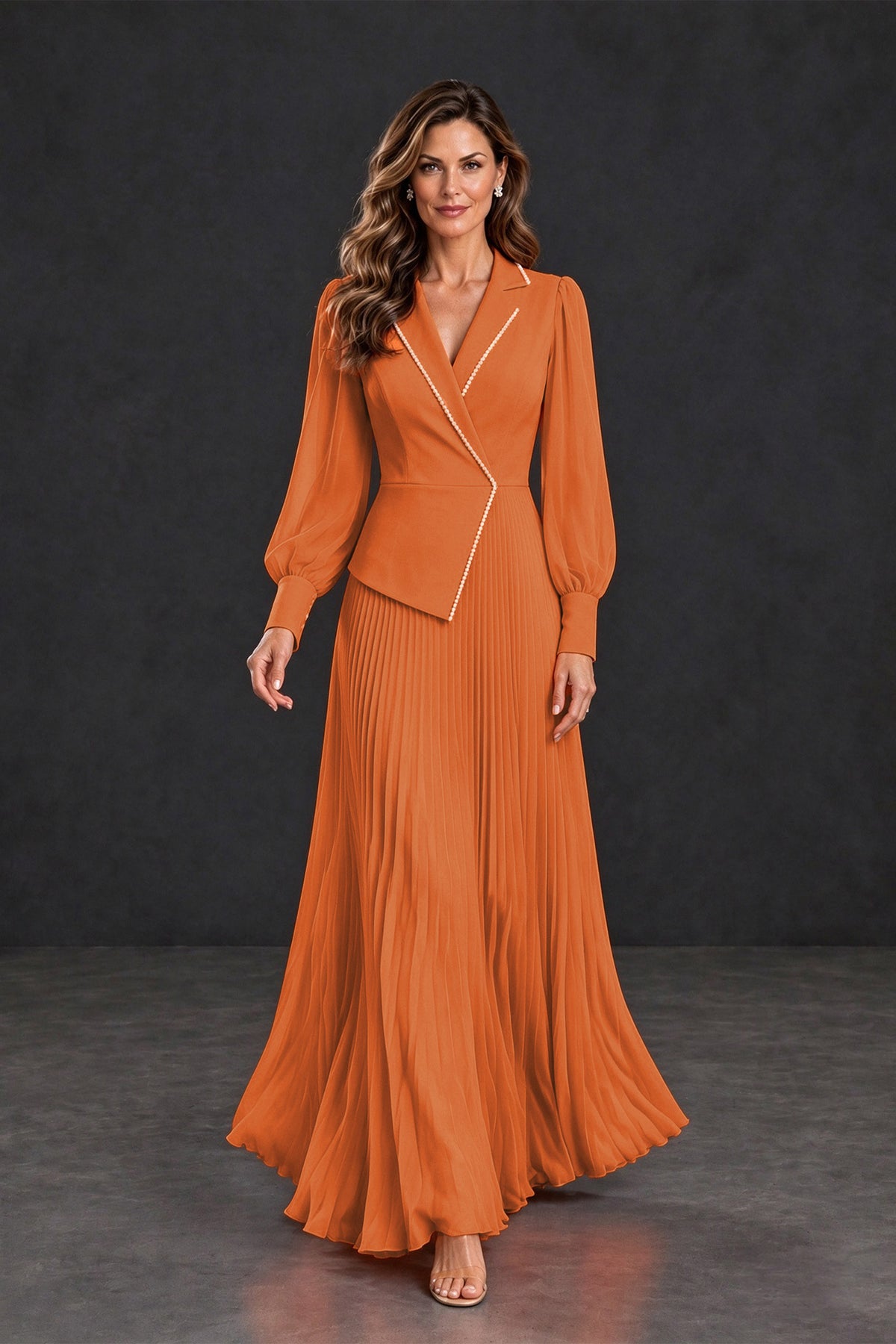 BOLODOO orange floor-length formal dress with flowing pleats and asymmetrical jacket-style bodice, walking view
