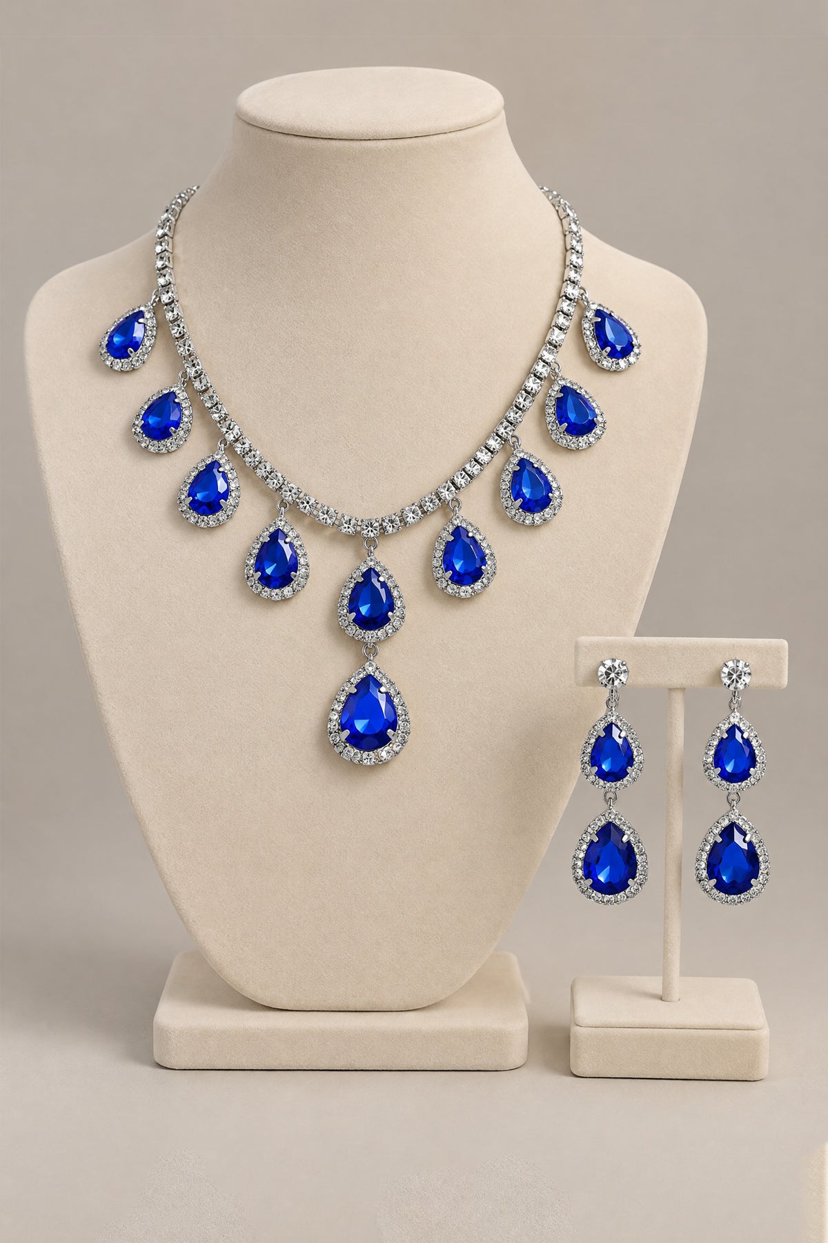 BOLODOO royal blue necklace and earrings set displayed on a jewelry bust and earring stand