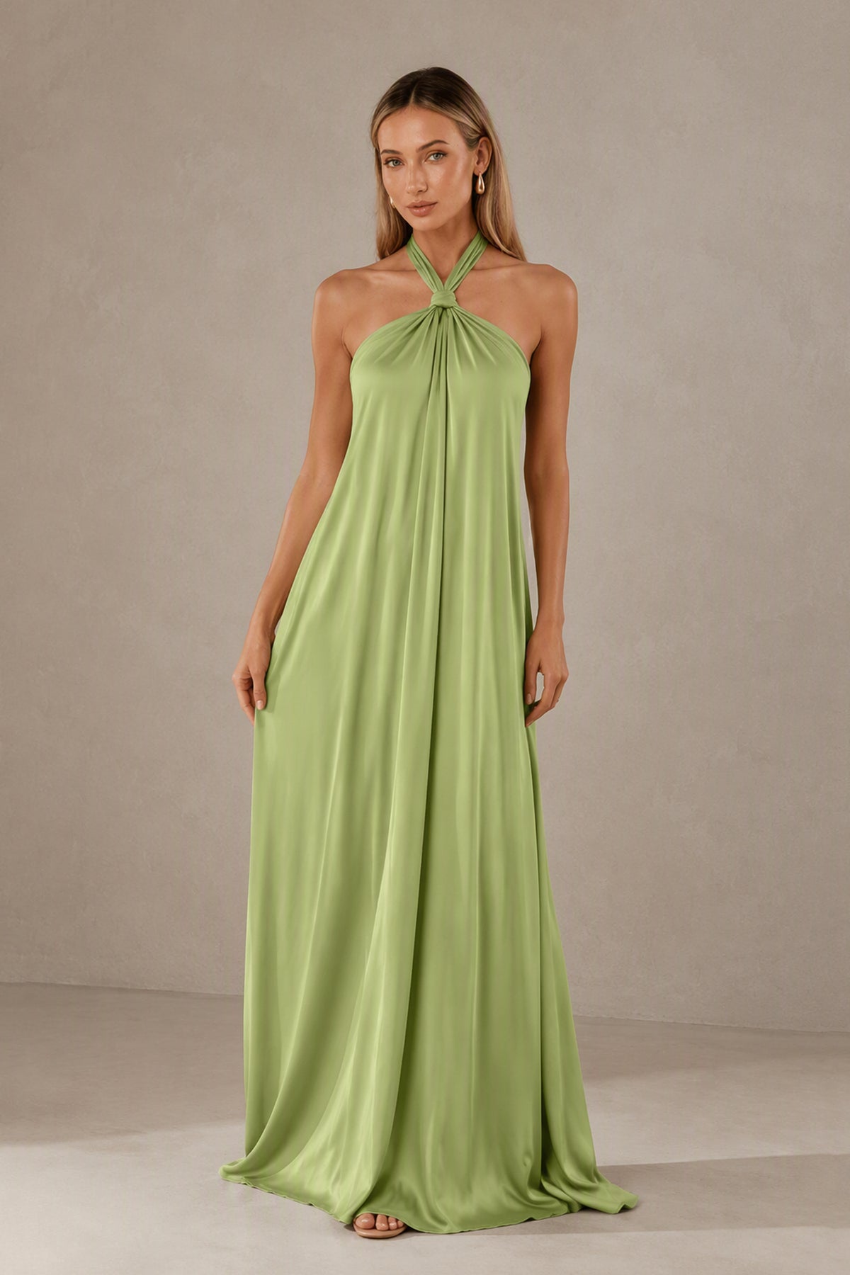 Side view of BOLODOO sage green sleeveless halter satin maxi dress with a fluid floor-length silhouette