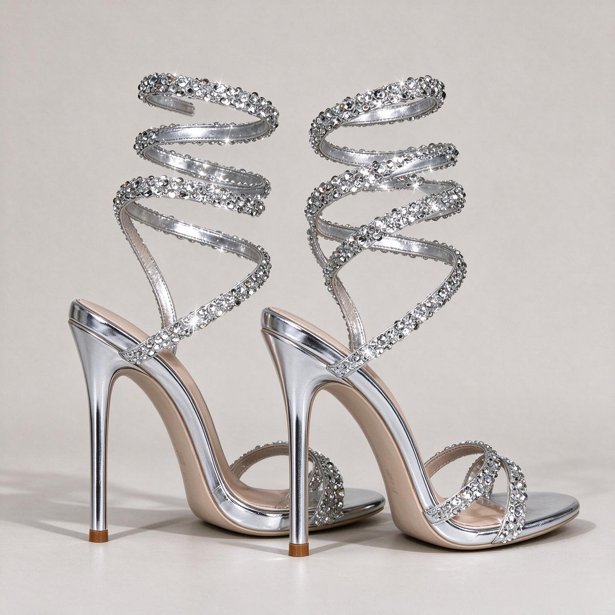 Side and rear view of BOLODOO silver rhinestone sandals with slim stiletto heels