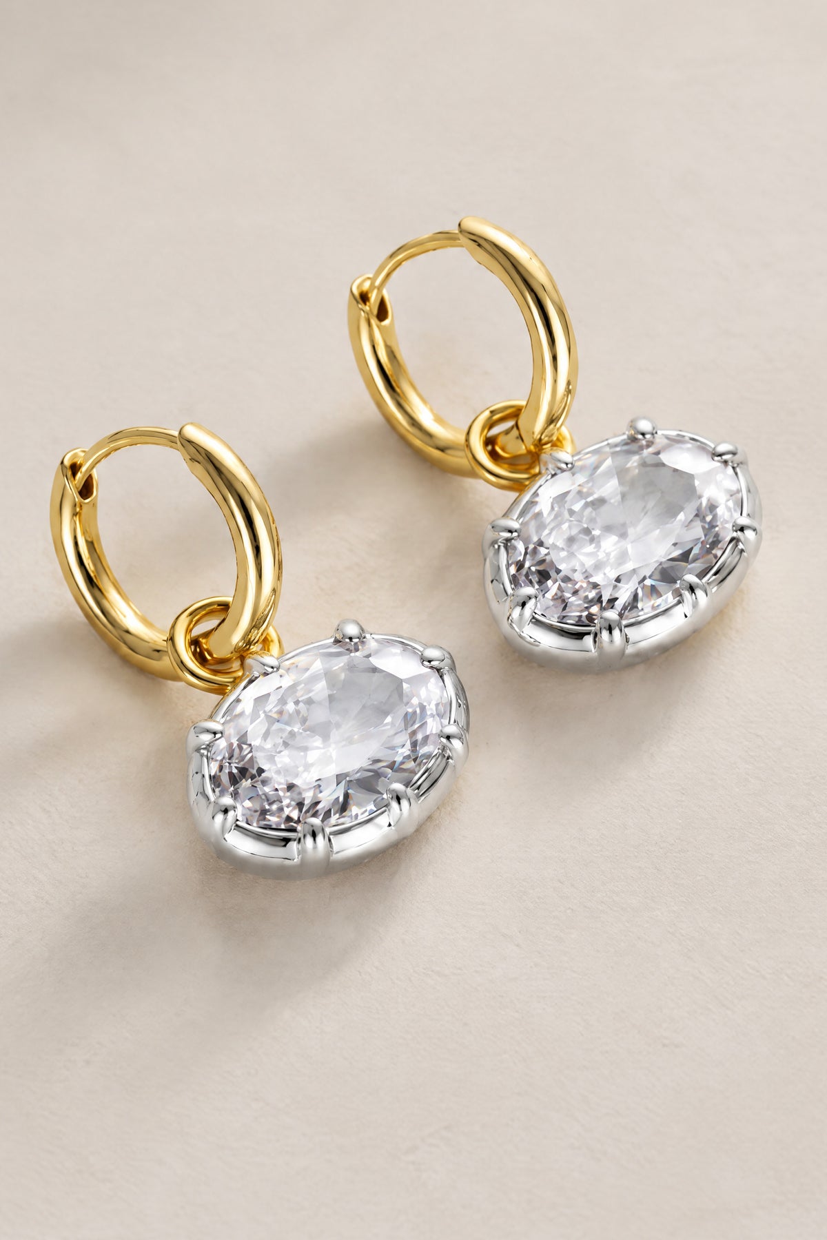BOLODOO QQ065 two-tone clear faceted drop earrings, angled flat-lay view