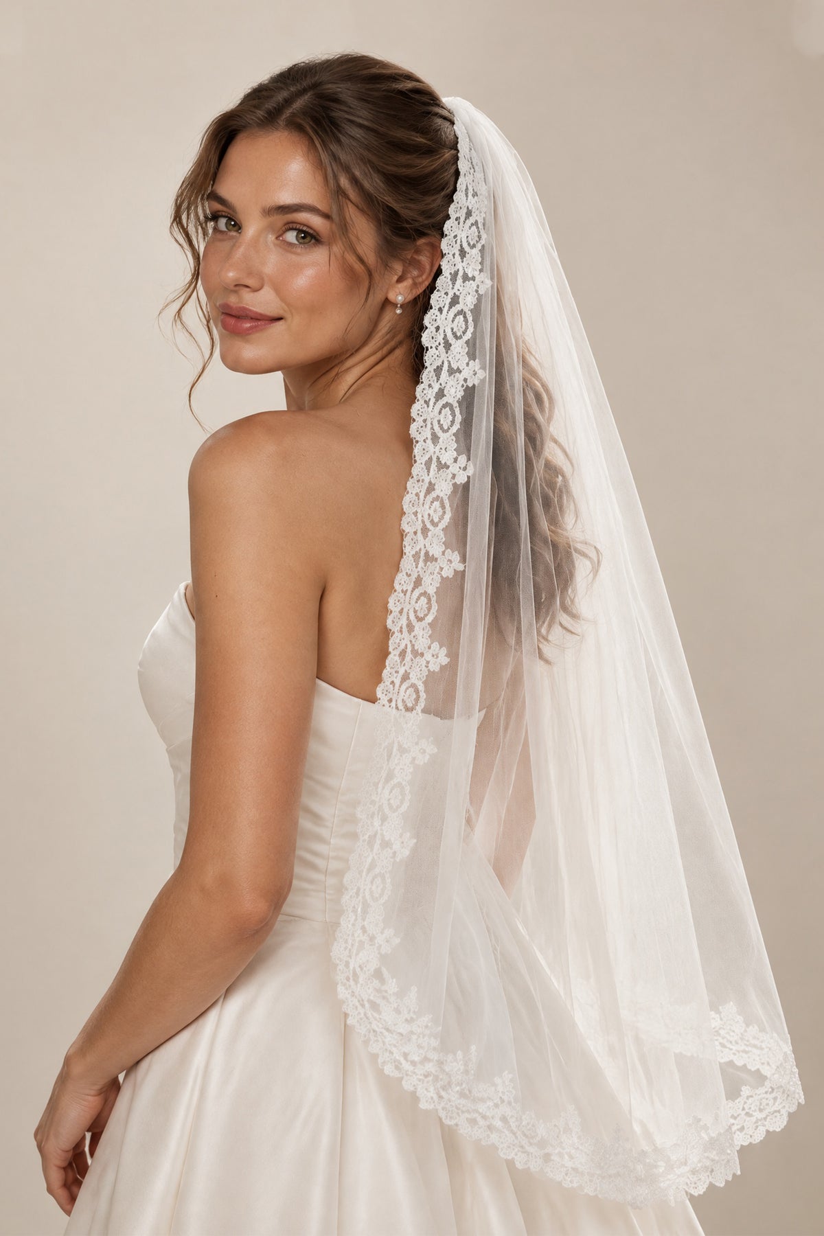 BOLODOO QQ083 white floral lace edge tulle bridal veil modeled in a three-quarter view