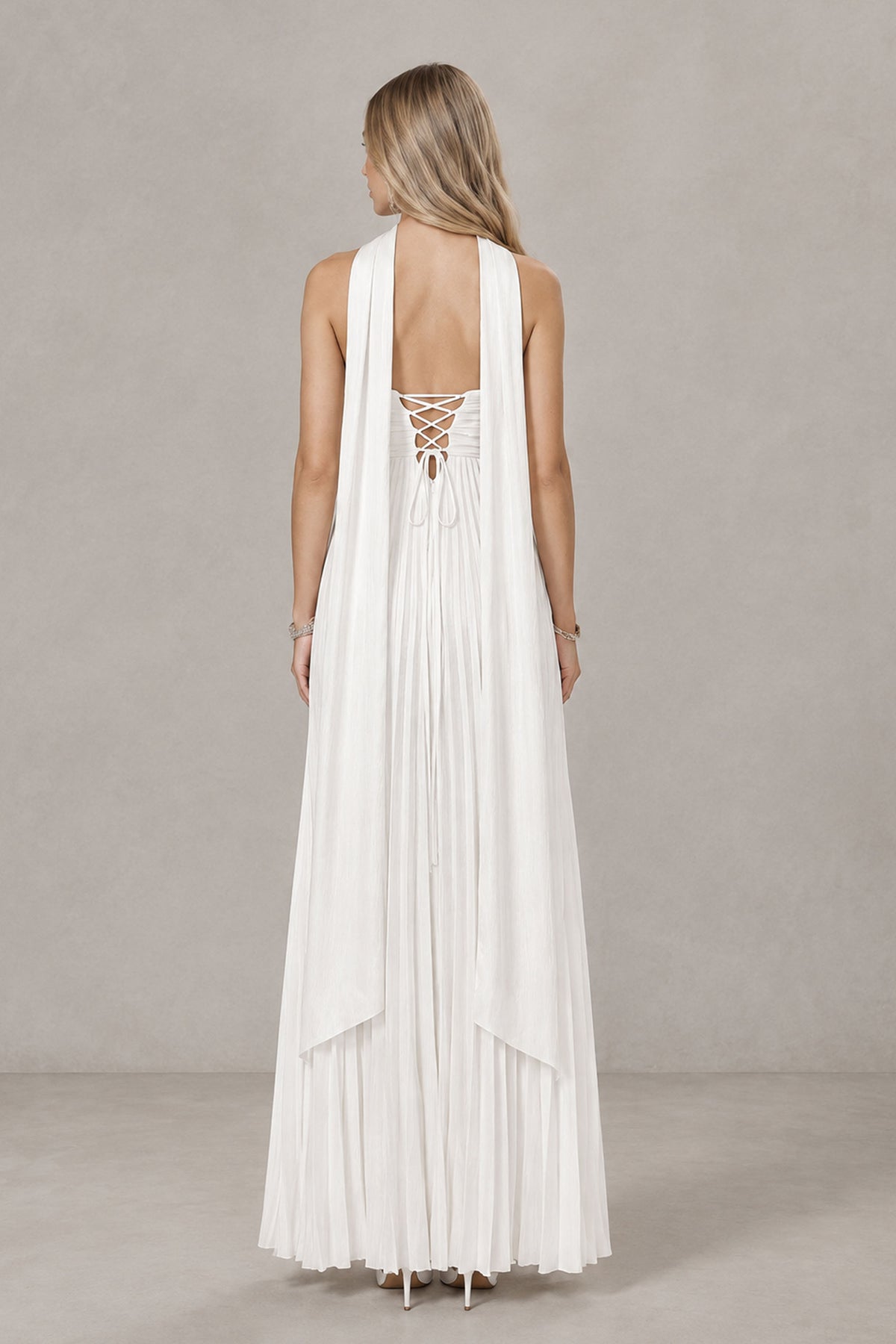 Back view of white strapless wedding dress showing lace-up open back and long scarf