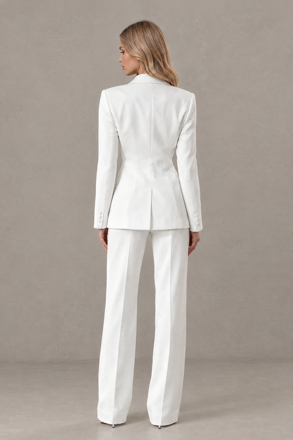 Back view of BOLODOO white pantsuit showing covered-back blazer with center vent and wide-leg trousers