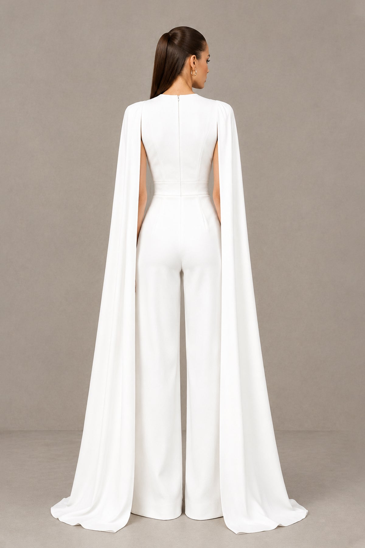 BOLODOO white bridal jumpsuit with covered zipper back and sweeping cape sleeve panels, back view