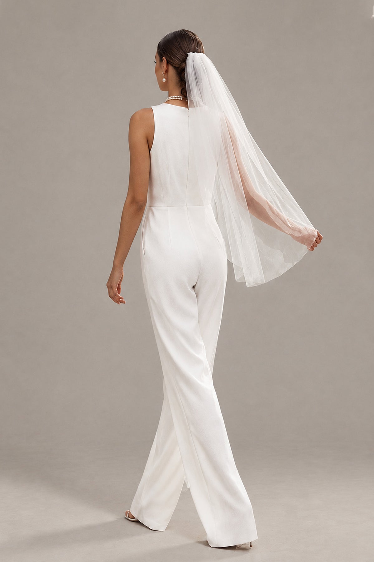 Back view of BOLODOO white sleeveless bridal jumpsuit with covered back and wide legs