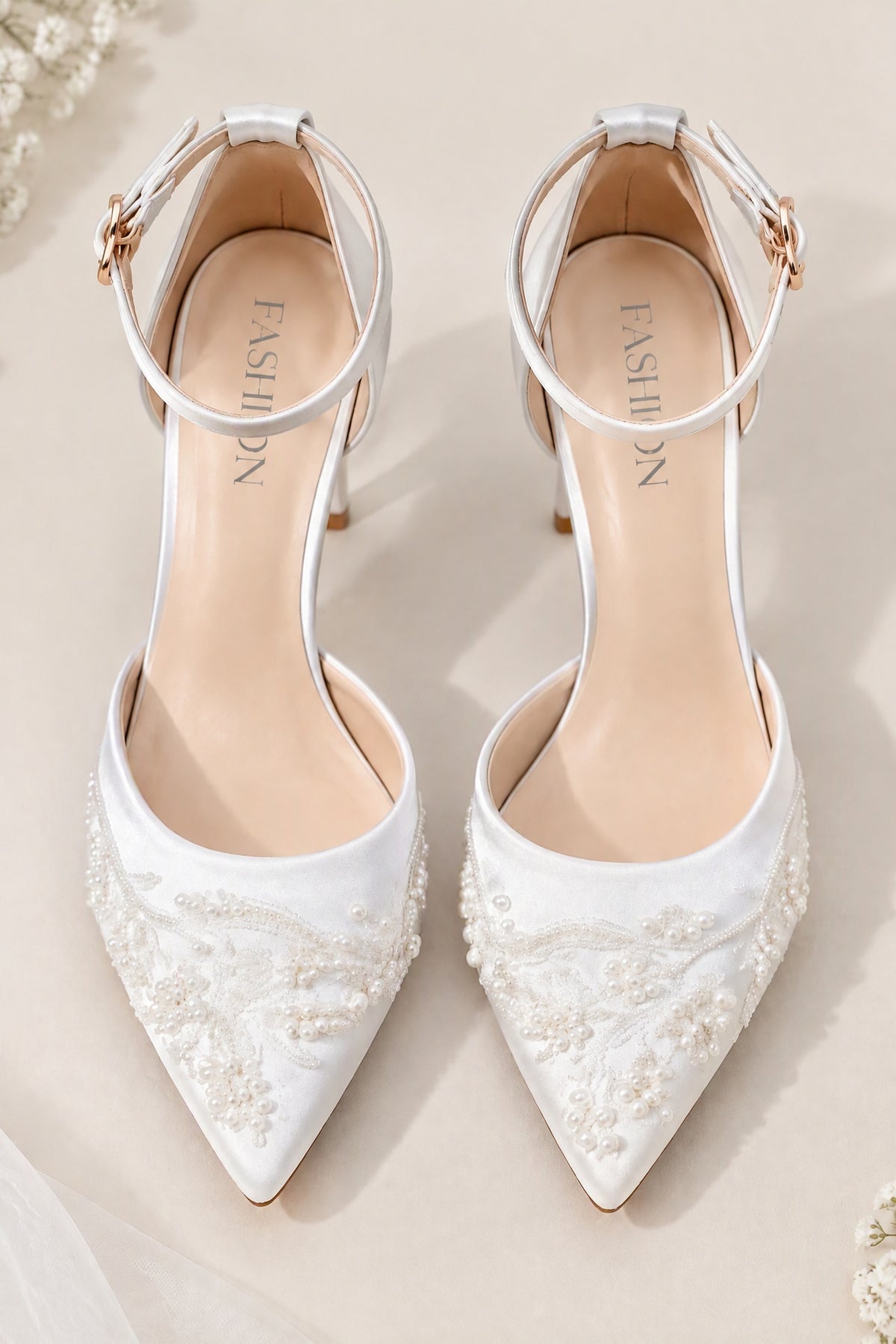 Front view of BOLODOO white pointed-toe bridal heels with pearl-like bead details and ankle straps