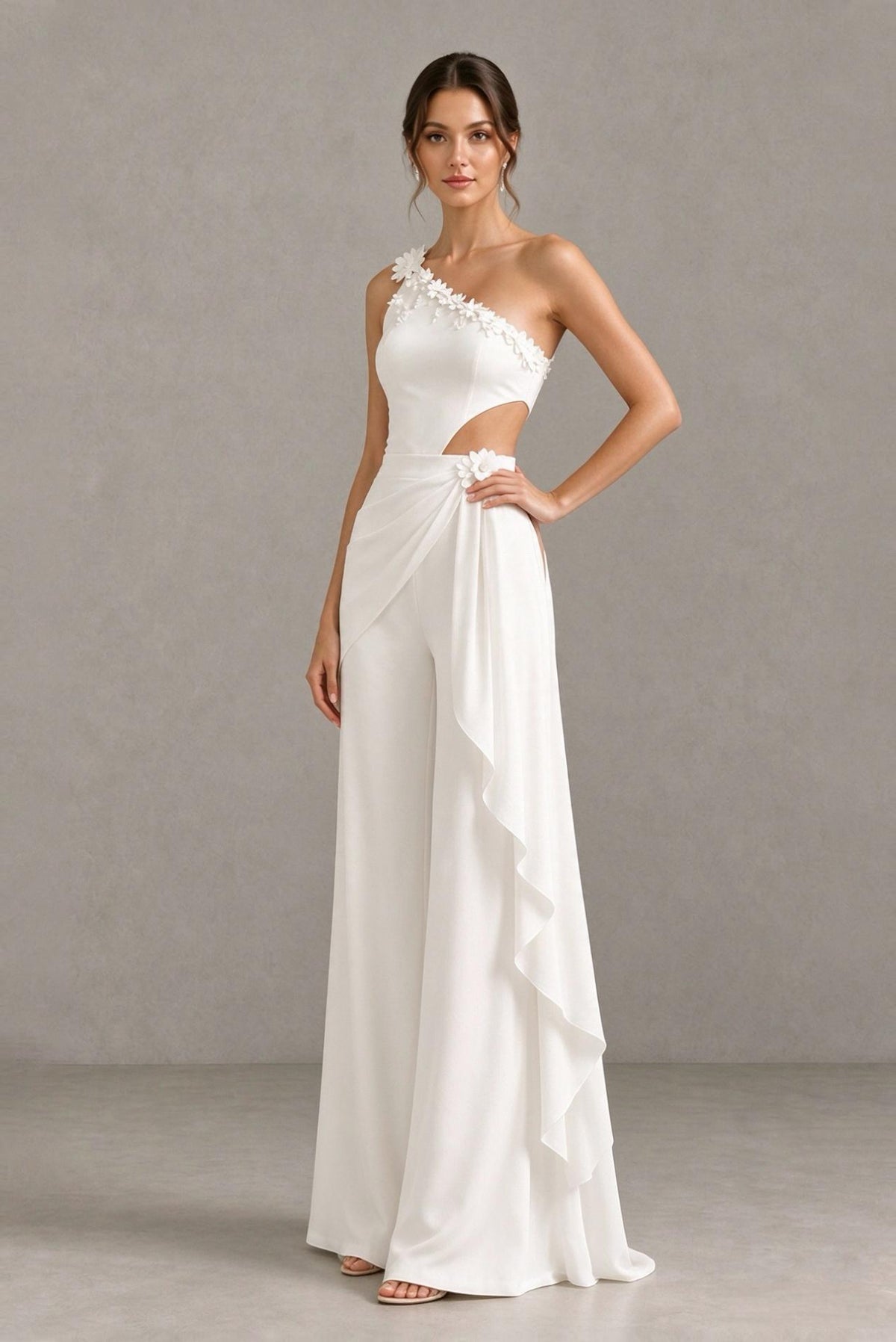BOLODOO white sleeveless bridal jumpsuit styled with hand on hip, floral applique detail