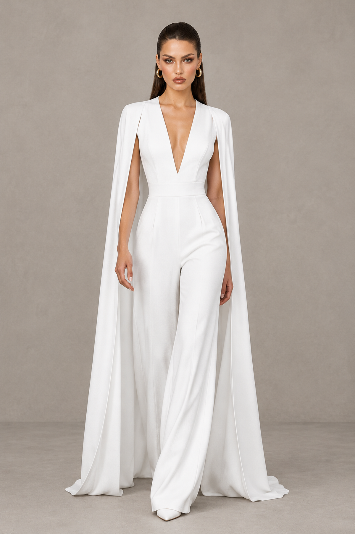 BOLODOO white cape sleeve bridal jumpsuit with flowing floor-length panels, walking front view