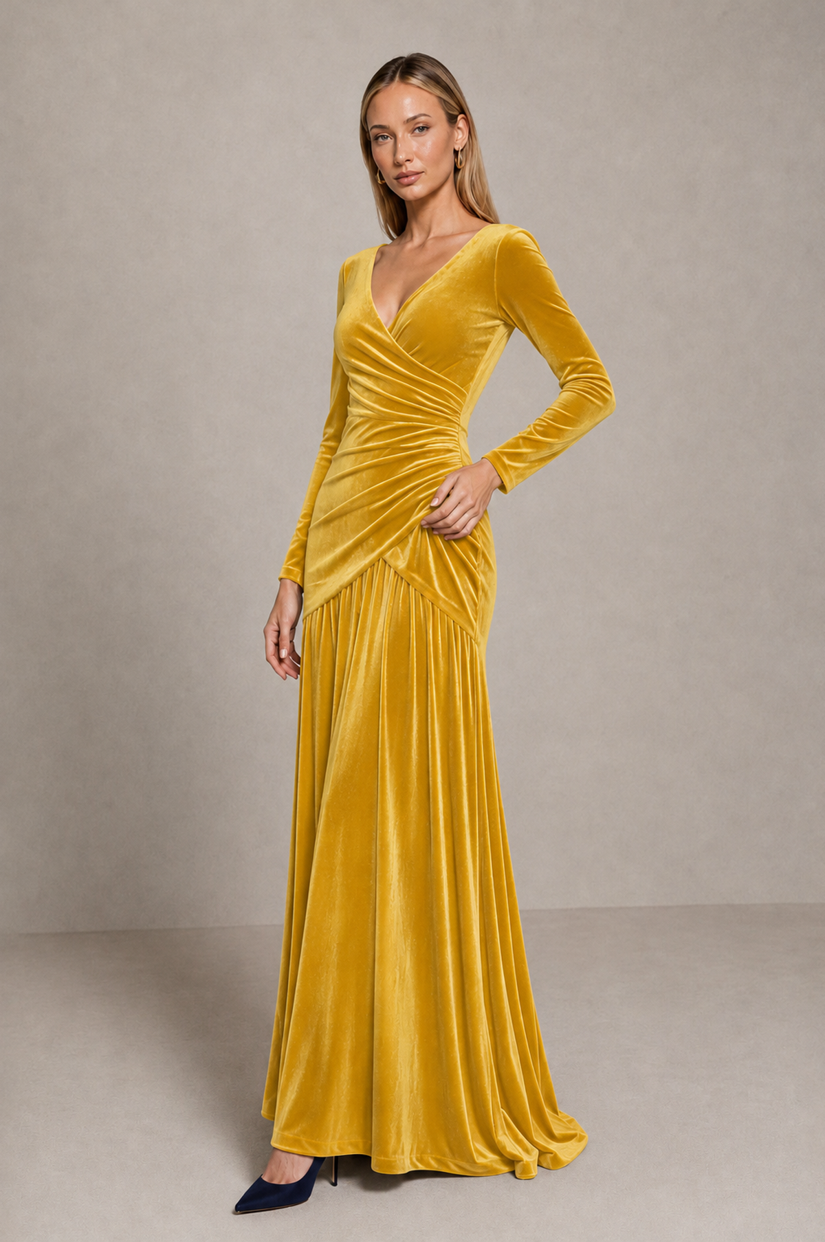 Angled view of BOLODOO yellow velvet evening dress showing long sleeves and diagonal waist ruching