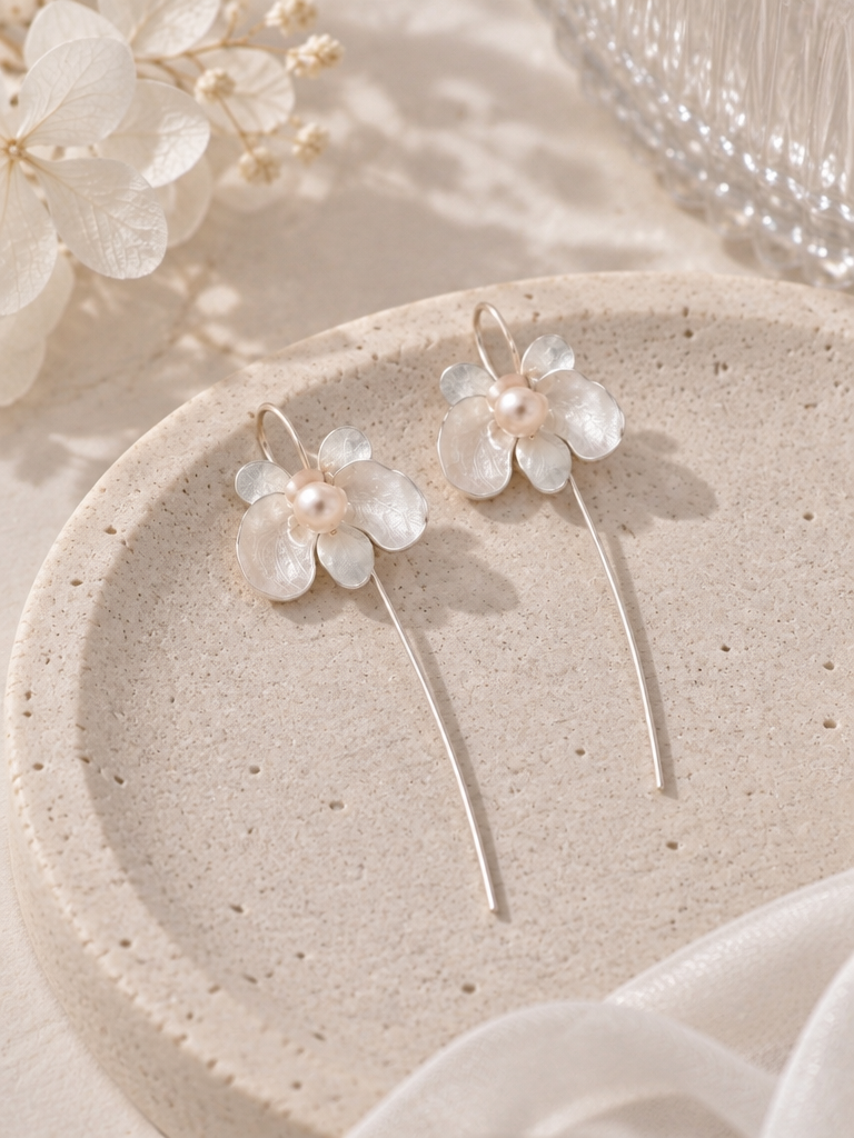 BOLODOO ivory flower earrings with pearl-look centers and long gold-tone curved drops, pair view